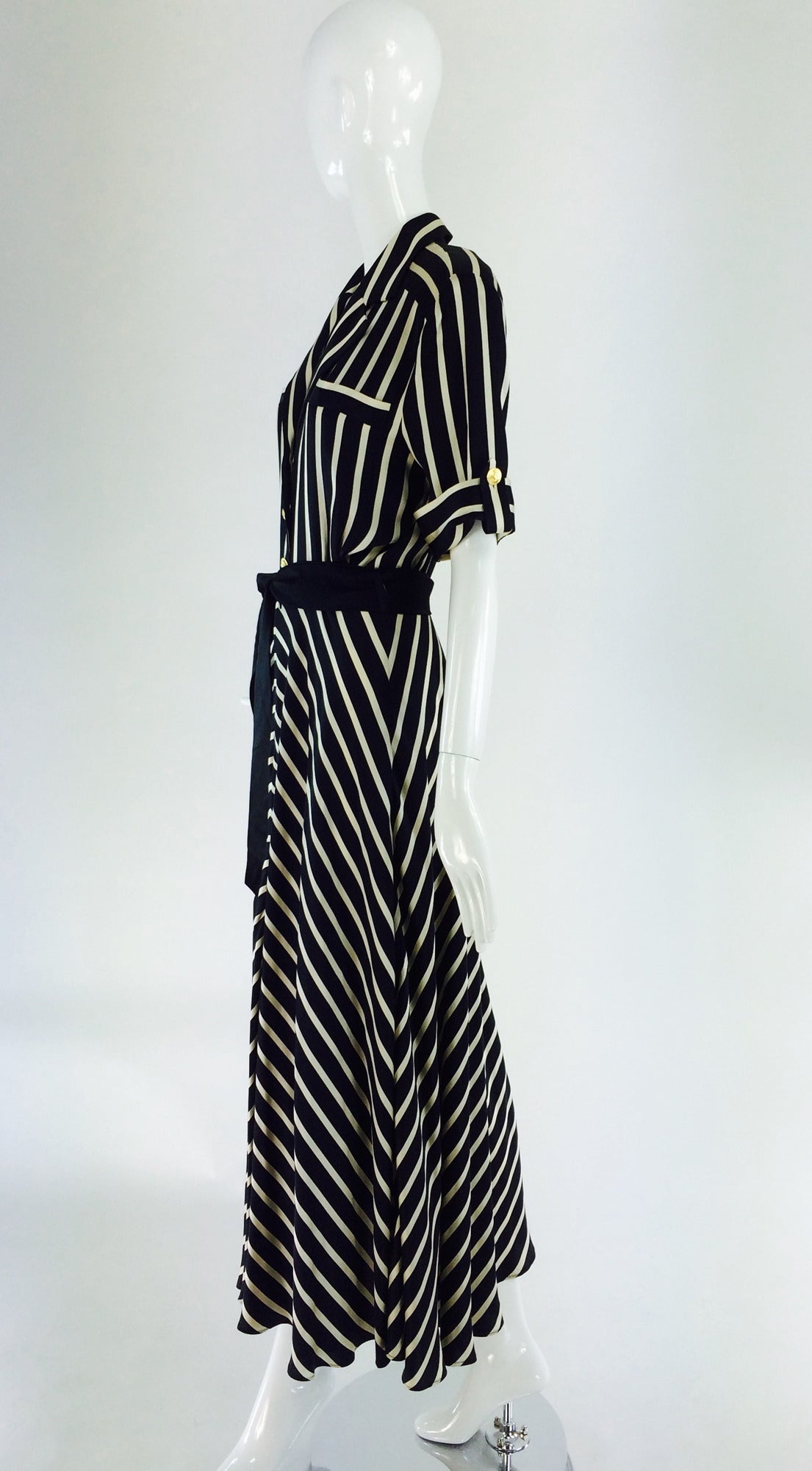 Black & ivory silk stripe dress from Escada 1980s...This dress features elbow length cuffed sleeves with gold button and tab details, notched lapels and a deep v neckline with gold button closure to the waist, with a hidden zipper from waist...