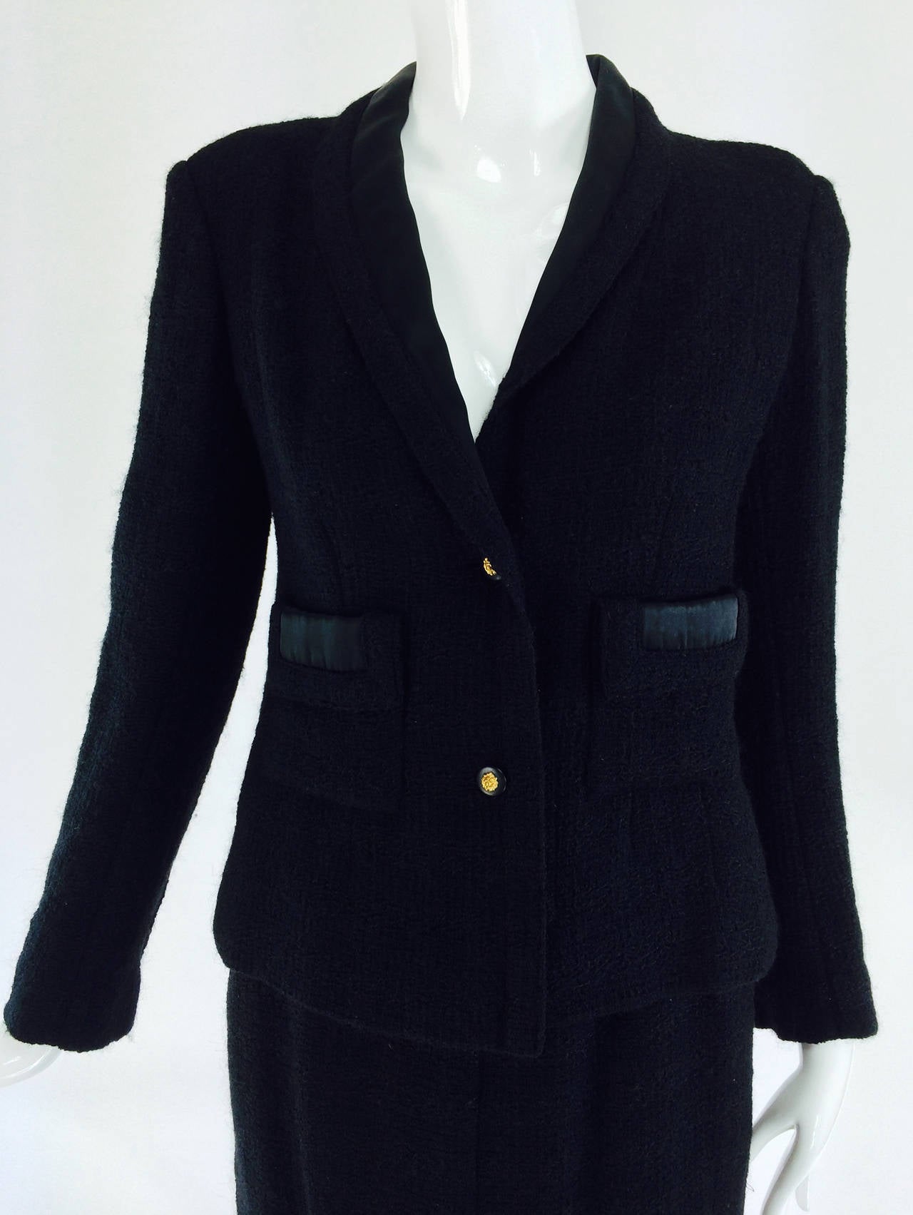 Chanel Creations-Paris black boucle wool suit Dated November 1, 1971. 'Chanel Creations', was the pret a porter/ready to wear label that was used until the Chanel Boutique label was introduced in 1983 when Karl Lagerfeld became creative director.