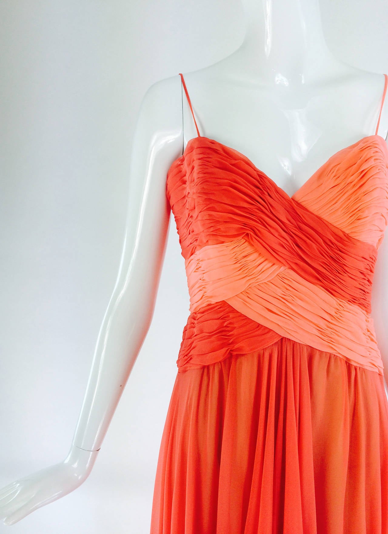 Loris Azzaro goddess gown in coral/peach silk chiffon 1970s...Old Hollywood glamour abounds in this goddess style gown by Loris Azzaro from the 1970s...Silk chiffon in coral and peach are shirred and then woven at the bodice in a design that is