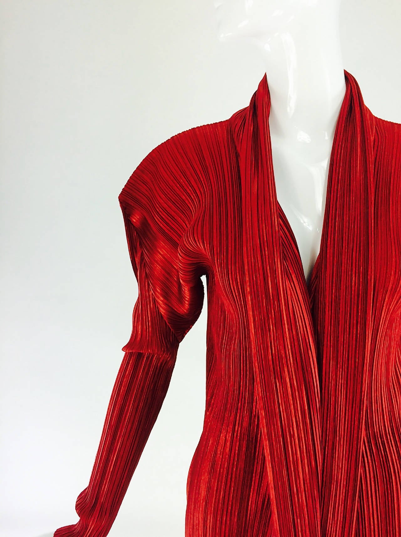 Issey Miyake pleated crimson red long jacket, with long pieced detail sleeves, deep shawl collar, closes at the front with buttons and loops...Marked size Medium...Looks barely, if ever, worn

Please check the measurements provided below and