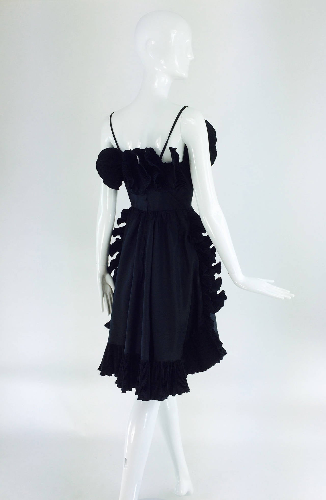 Frank Usher, London black taffeta ruffle pleat trim cocktail dress 1970s...Sculptural trim, done in narrow accordion pleated ruffles that stand on their own, cocktail dress...Fitted boned bodice dress has narrow shoulder straps, the skirt is