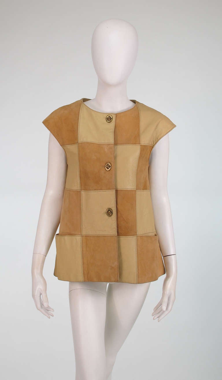 1950s Bonnie Cashin for Sills, patchwork suede & leather vest...Extended shoulder vest constructed of blocks of creamy tan leather and beige suede...A line shape with hip front pockets...Closes with signature brass turn locks down the front...Fully