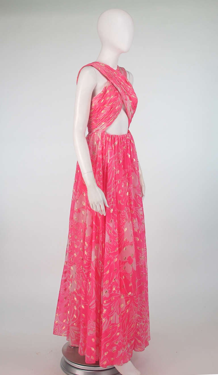 Glamourous  like old Hollywood, one of the best Malcolm Starr gowns we’ve ever seen!  The gorgeous pink and white chiffon print is splashed with gold metallic throughout adding just the right amount of sparkle…The draped bodice wraps at the front