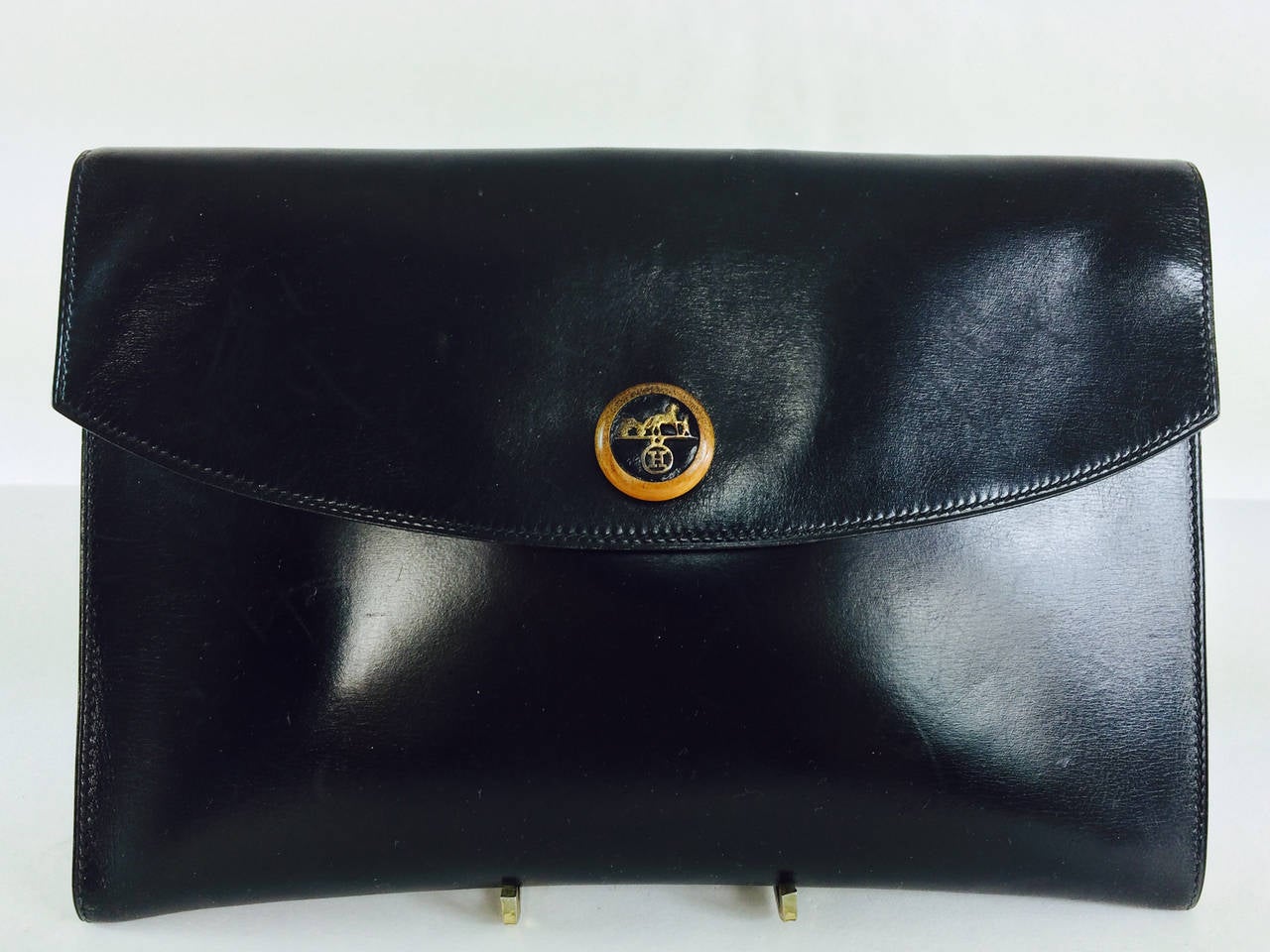 Hermes Pochette Rio in glazed black calf, vintage...Sleek clutch with envelope shape, flap closes with a wooden/leather/metal caleche logo...there are gold chains at either top inside...Fully lined in black calf...In very good vintage