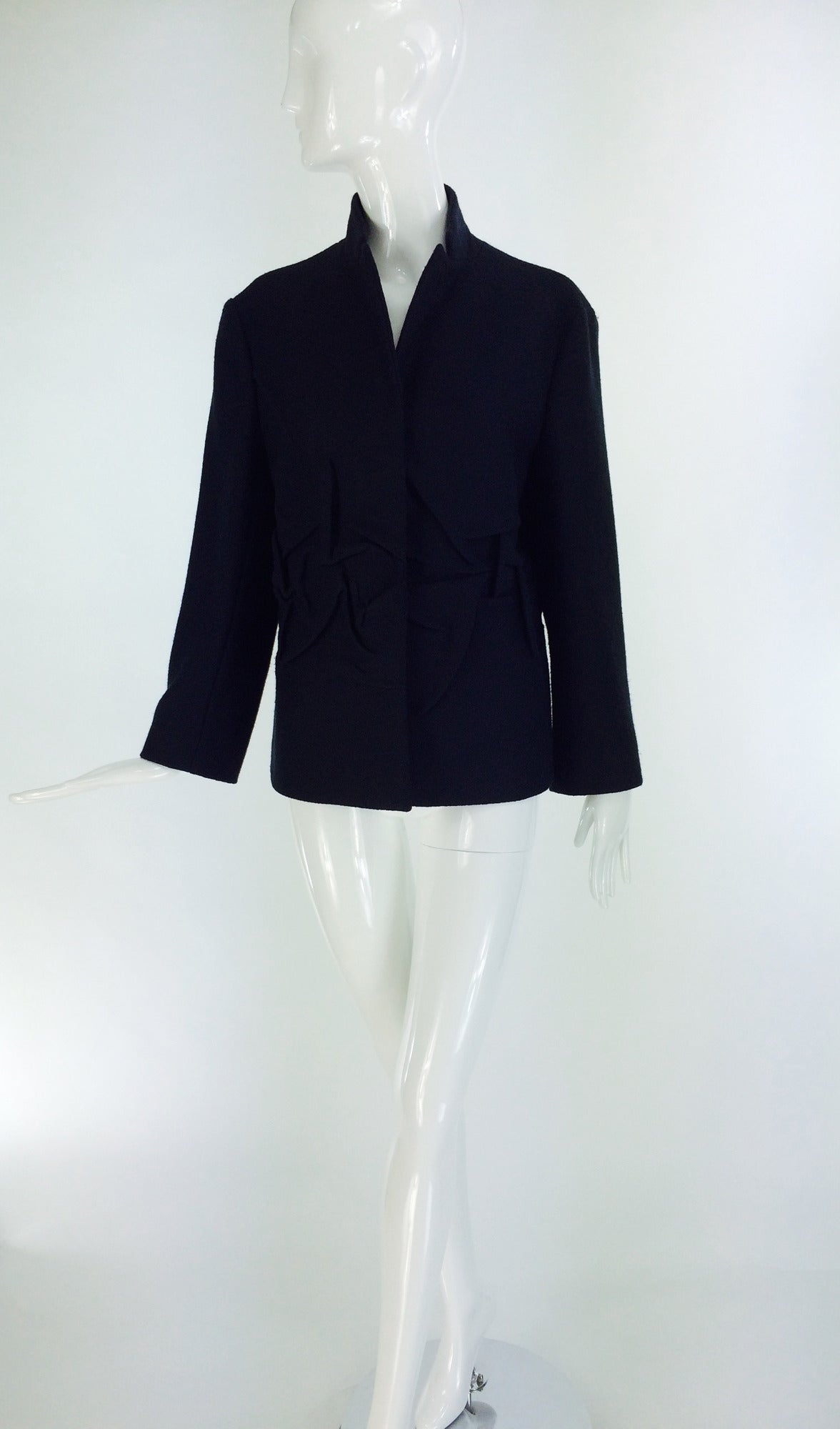 Jil Sander black wool jacket with 3 D sculpted panels...Single, hidden button front jacket, has a stand up, notched lapel collar...All around at the approximate waist there are panels of 3 D shaped sculpted wool, which adds dramatic texture and