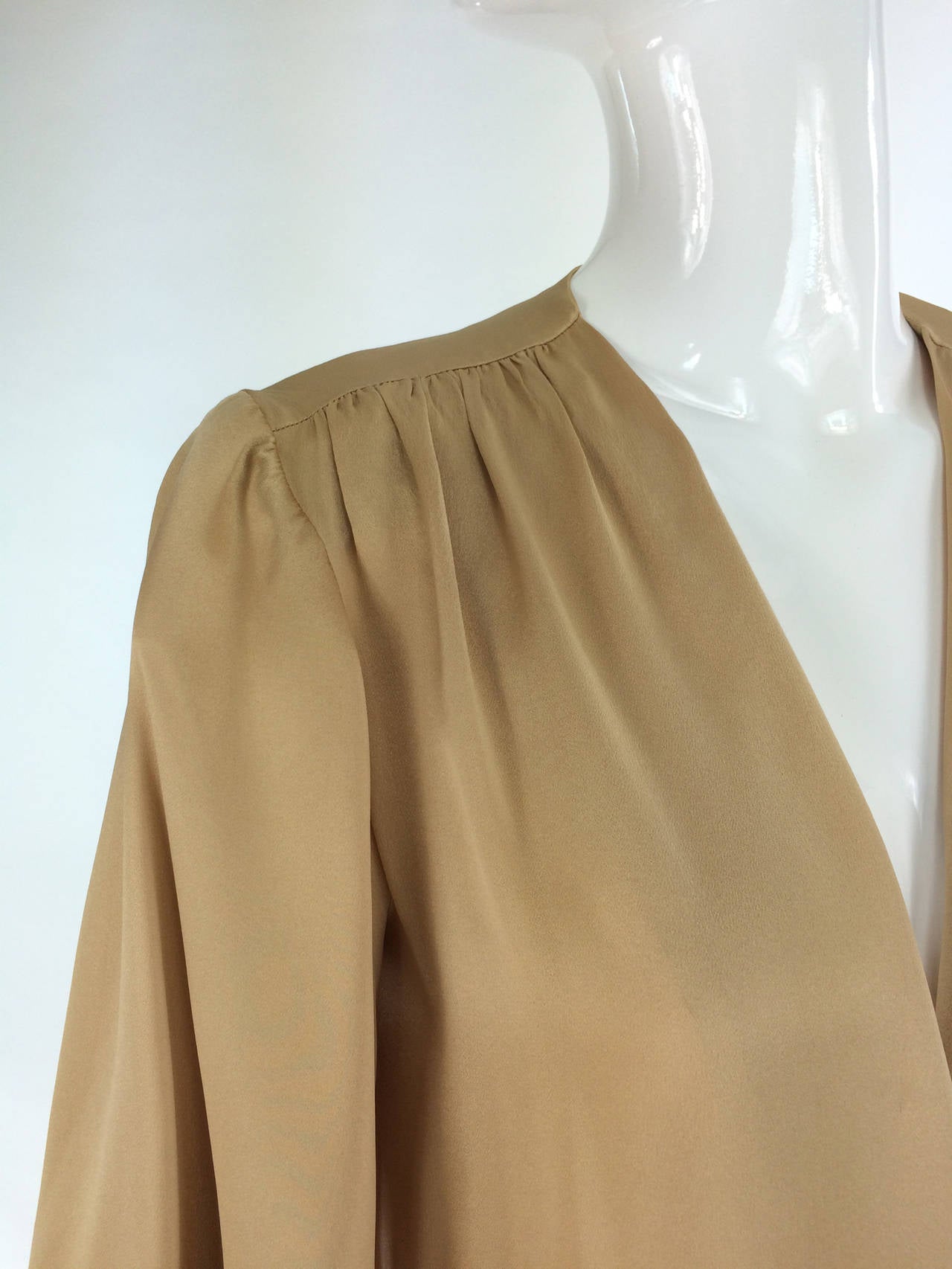 Yves St Laurent Rive Gauche gold silk satin blouse 1990s...Long sleeve blouse with button cuffs, yoke front, open front blouse has no closures..beautiful gold charmeuse silk...Marked size 34...Freshly dry cleaned and ready to wear...

Please check