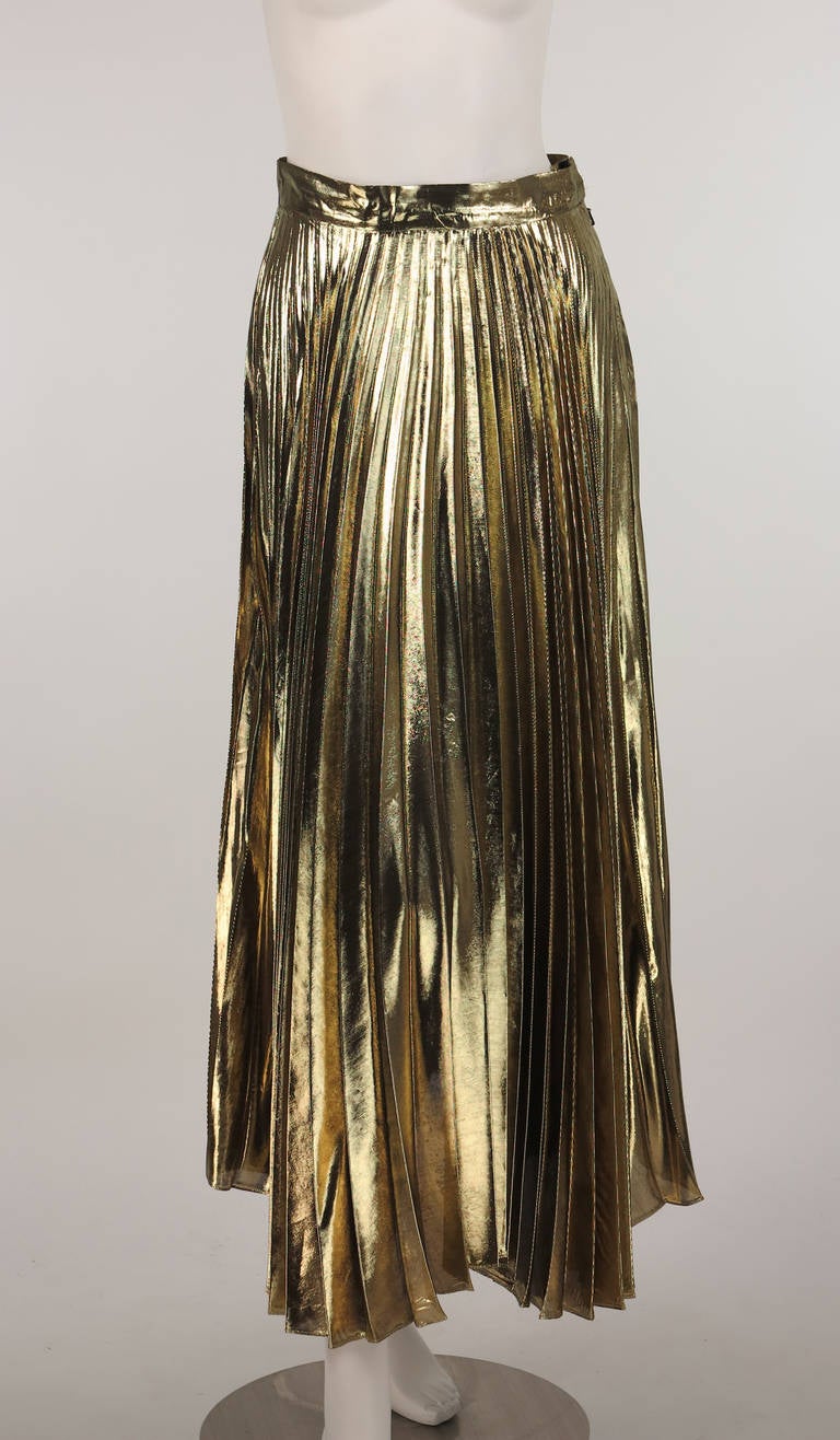 Liquid gold knife pleated skirt new with tags...Halston 1980s...Ballet length...Shimmering gold knife pleated skirt, sits at natural waist...Unlined, closes with a double bar hook and zipper...Marked size 6, will fit a modern 4-6...In excellent