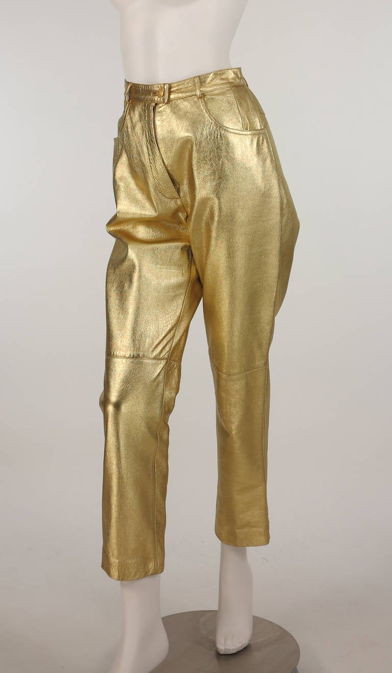 Soft gold leather blue jean styled trouser from the 1980s from Salvatore Ferragamo...Banded waist sits at natural waist, belt loops with gold button at front, fly front...hip front darts, scoop front pockets...Leather is in excellent