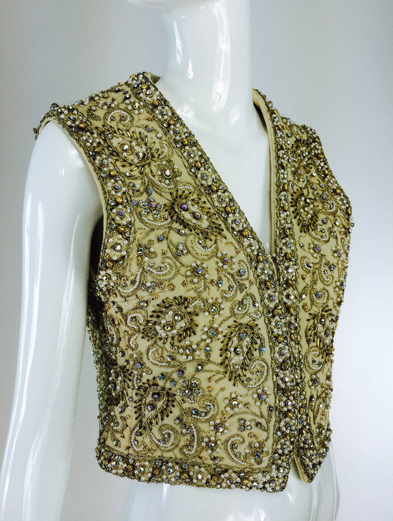 Marie McCarthy for Larry Aldrich gold sequin & rhinestone beaded vest 1960s...This beautiful vest of cream wool is heavily covered in glittery crystal sequins and beads, pearls, gold cord work, and gold beading...From the mid 1960s..Fully lined in