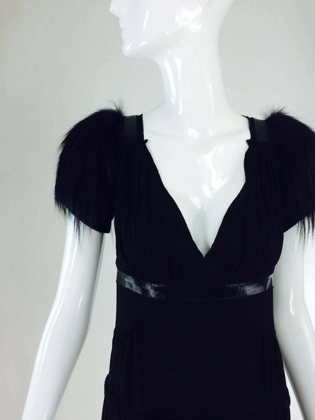 Prada black fox fur sleeve plunge front cocktail dress from 2007 with tags, retail $2365.  V plunge neckline and back with a tie at the neck back to keep the dress in place. The shoulder tops are covered with black fox fur, the sleeves are knit. The