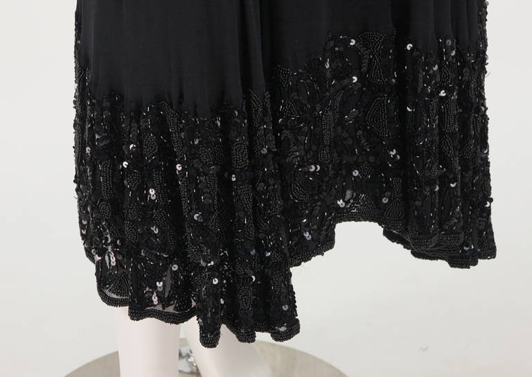 Gorgeous black chiffon skirt with under layers of chiffon and silk...The deep hem band is covered with black sequins and beads making an unusual skirt for evenings and special events...Banded waist and zipper closure with snaps at the waist...Fits