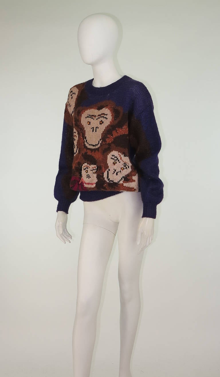 From the animal series of knit sweaters designed by Mariuccia Mandelli durning the 1980s, The Monkey Family...Over sized open knit purple mohair sweater has a family of happy monkeys across the front, their arms extend down the arms of the