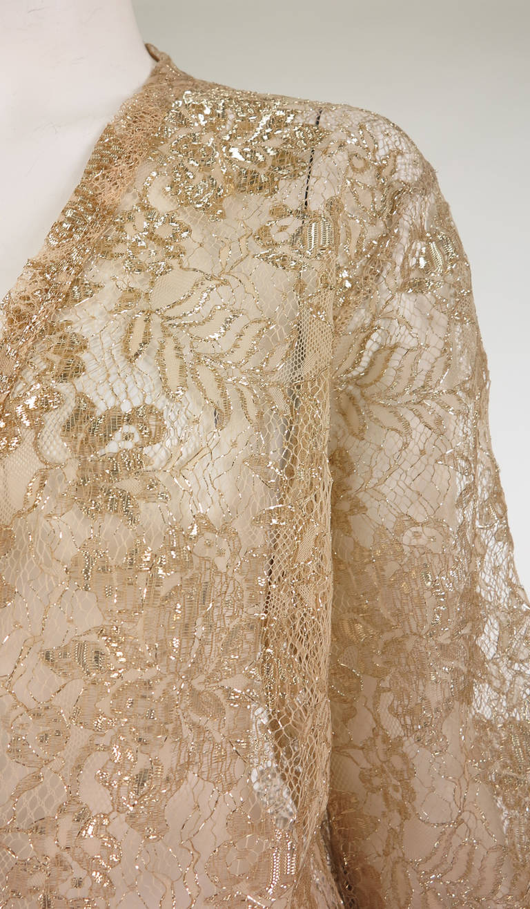 Glittery gold lace open front jacket, labeled Isadora Paris...Lace trimmed facings, belted this would make a lovely evening blouse...Unlined...Fits 8-10...

In excellent wearable condition... All our clothing is dry cleaned and inspected for