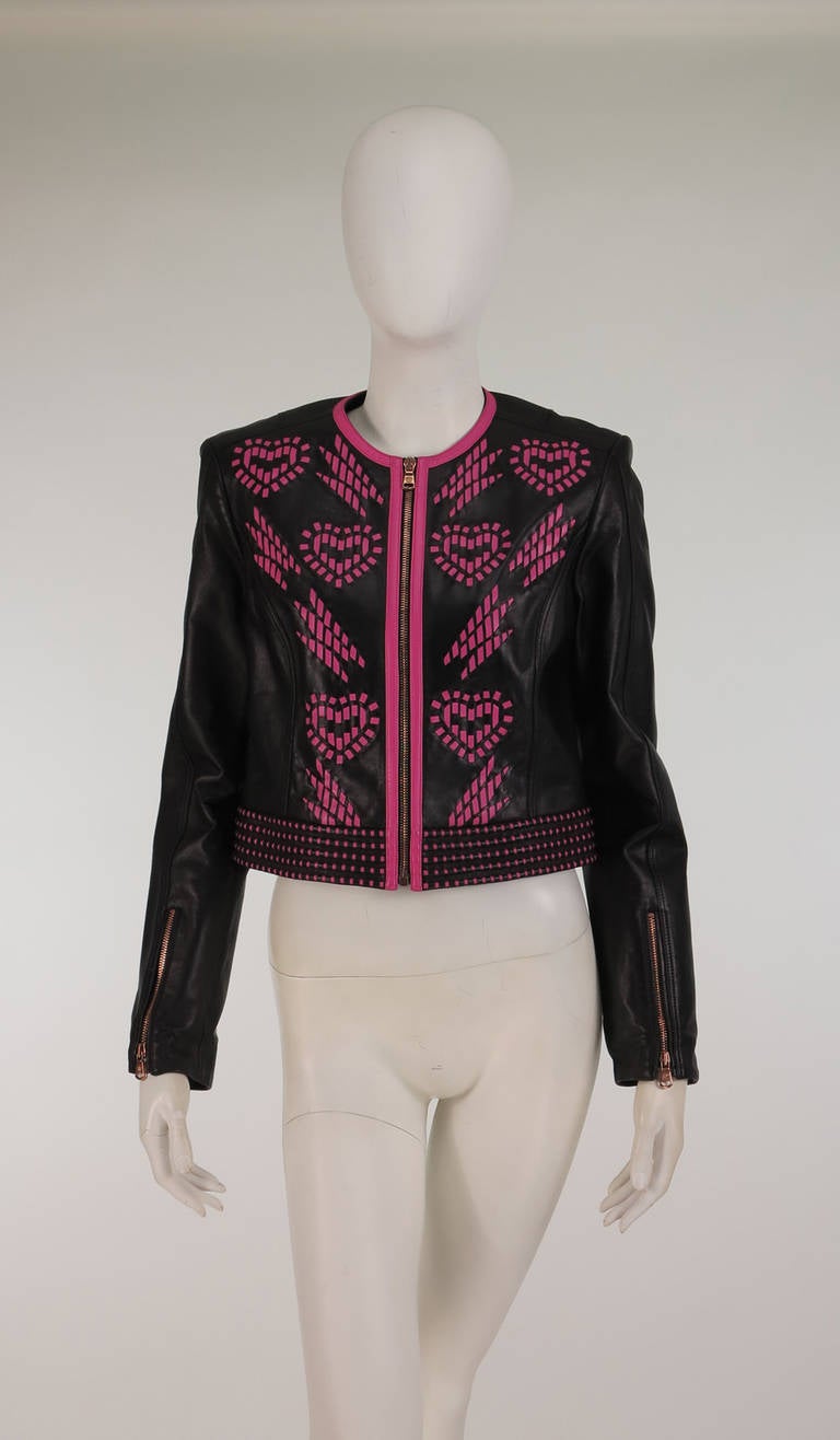 Versace soft black leather motorcycle influenced cropped jacket...Zipper front, zipper cuffs...Laser cut pink leather laced heart design at the front...Padded stitch waist band...Marked size 42...Unworn...

Measurements are:
Bust  36