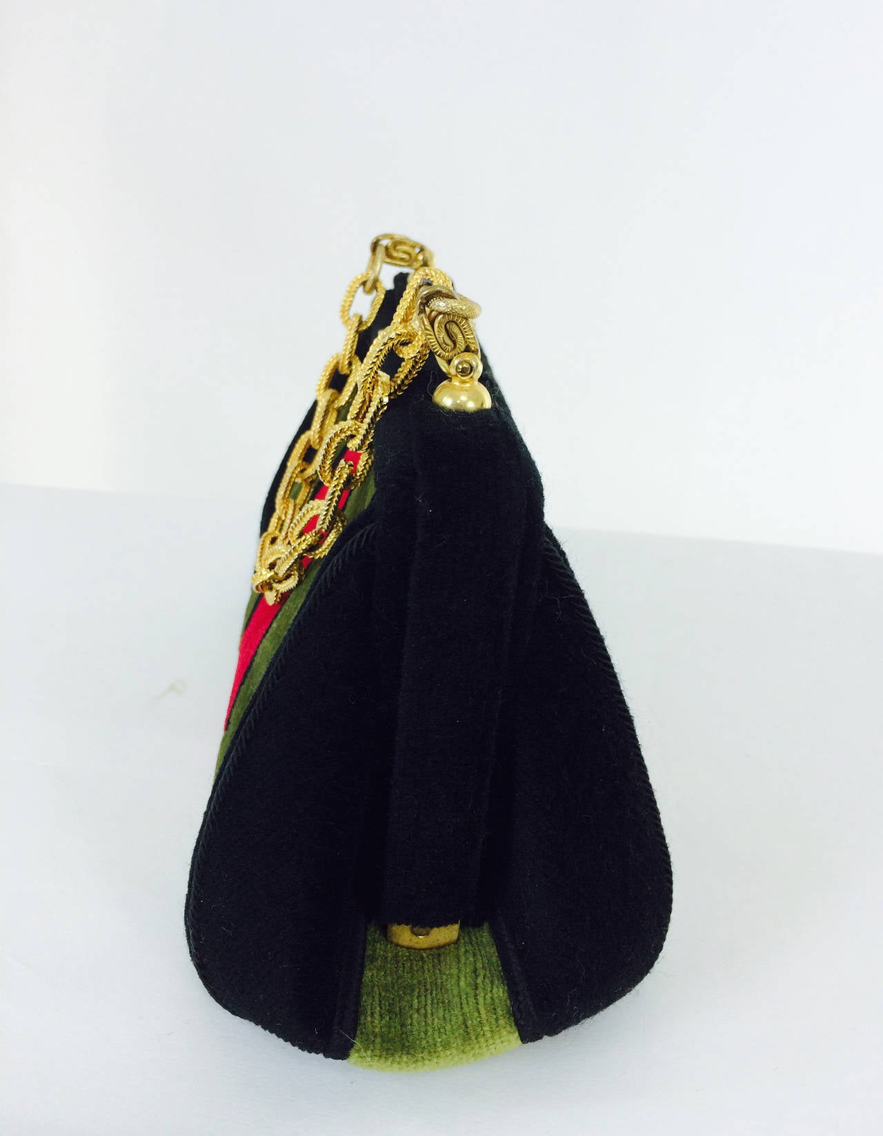 Velvet chain handle bag in red, black & green 1970s...Purchased in Italy in the 1970s, in the manner of Roberta di Camerino...Black, pea green and red velvet frame bag has a gold plated chain handle and decorative snap closure...The interior is