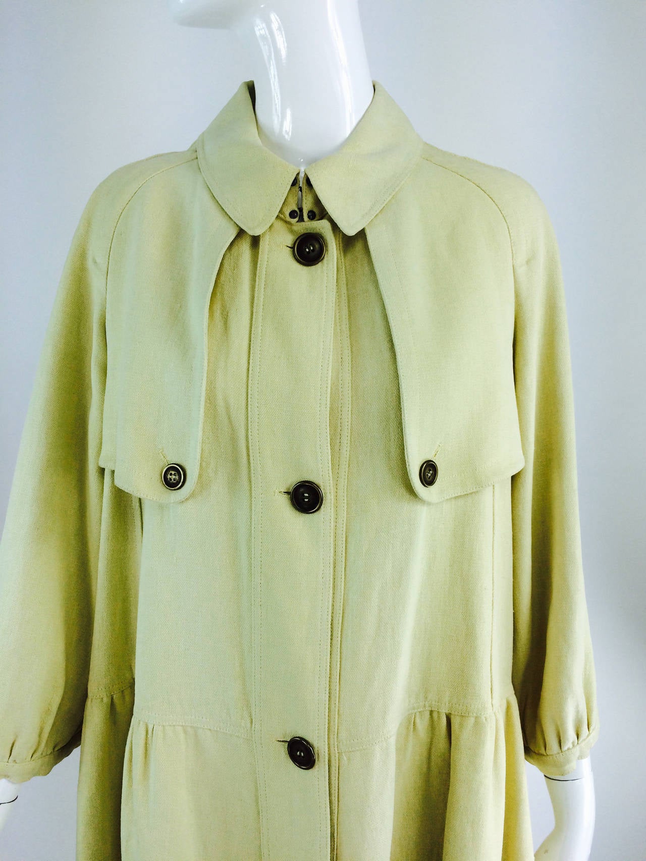 Burberry butter yellow hemp coat dress 2005...Butter yellow hemp coat dress has a full silhouette, with 3/4 length raglan sleeves that are gathered into a narrow cuff...Shoulder flap front & back...The skirt is gathered and full at the hip...Hip