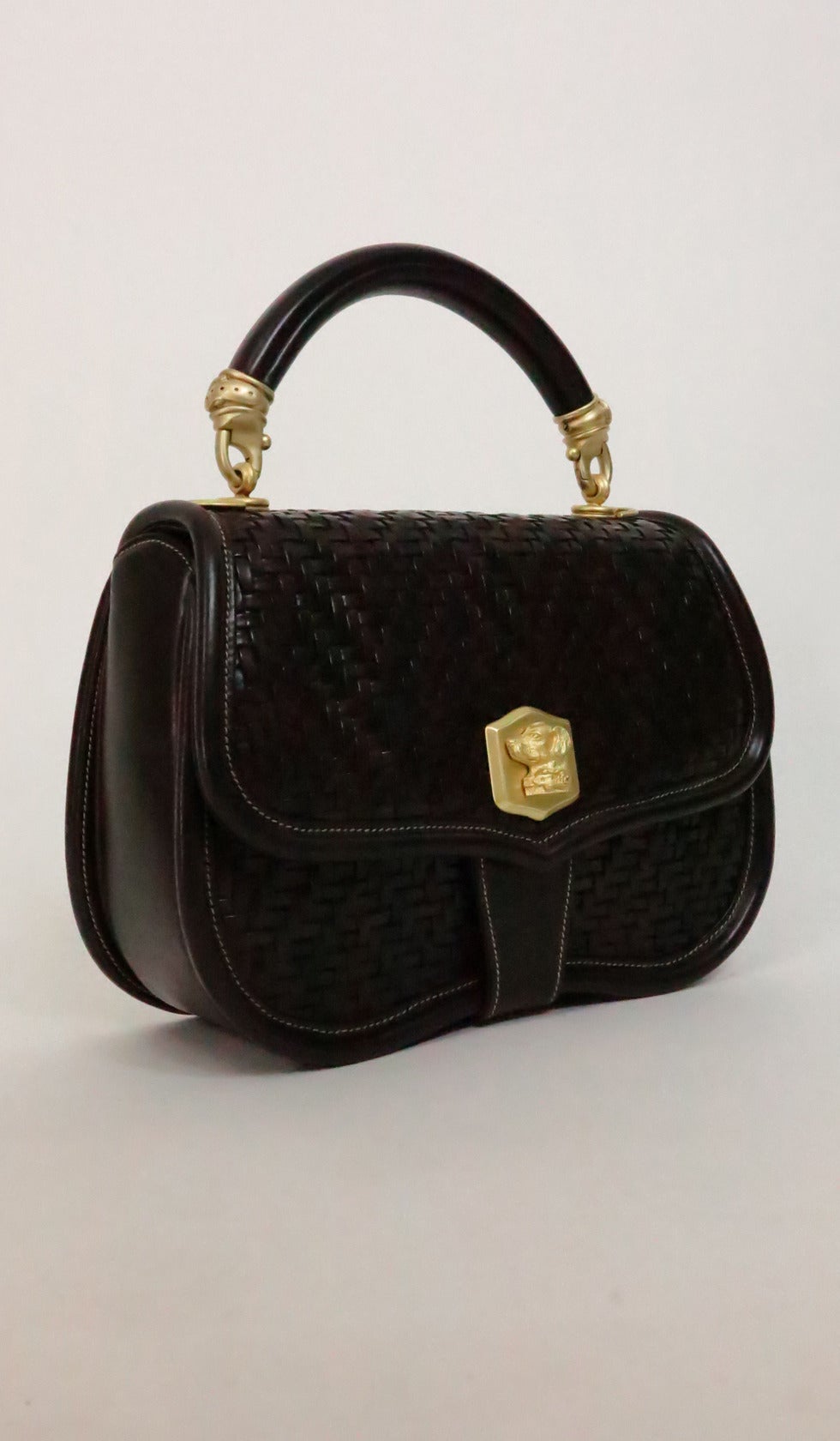 Rich chocolate brown woven leather handbag from  Kieselstein-Cord…Matte gold hardware the front features a Labrador retriever turn clasp, the leather handle has matte gold figural dog collar hardware, there is an attached leather shoulder