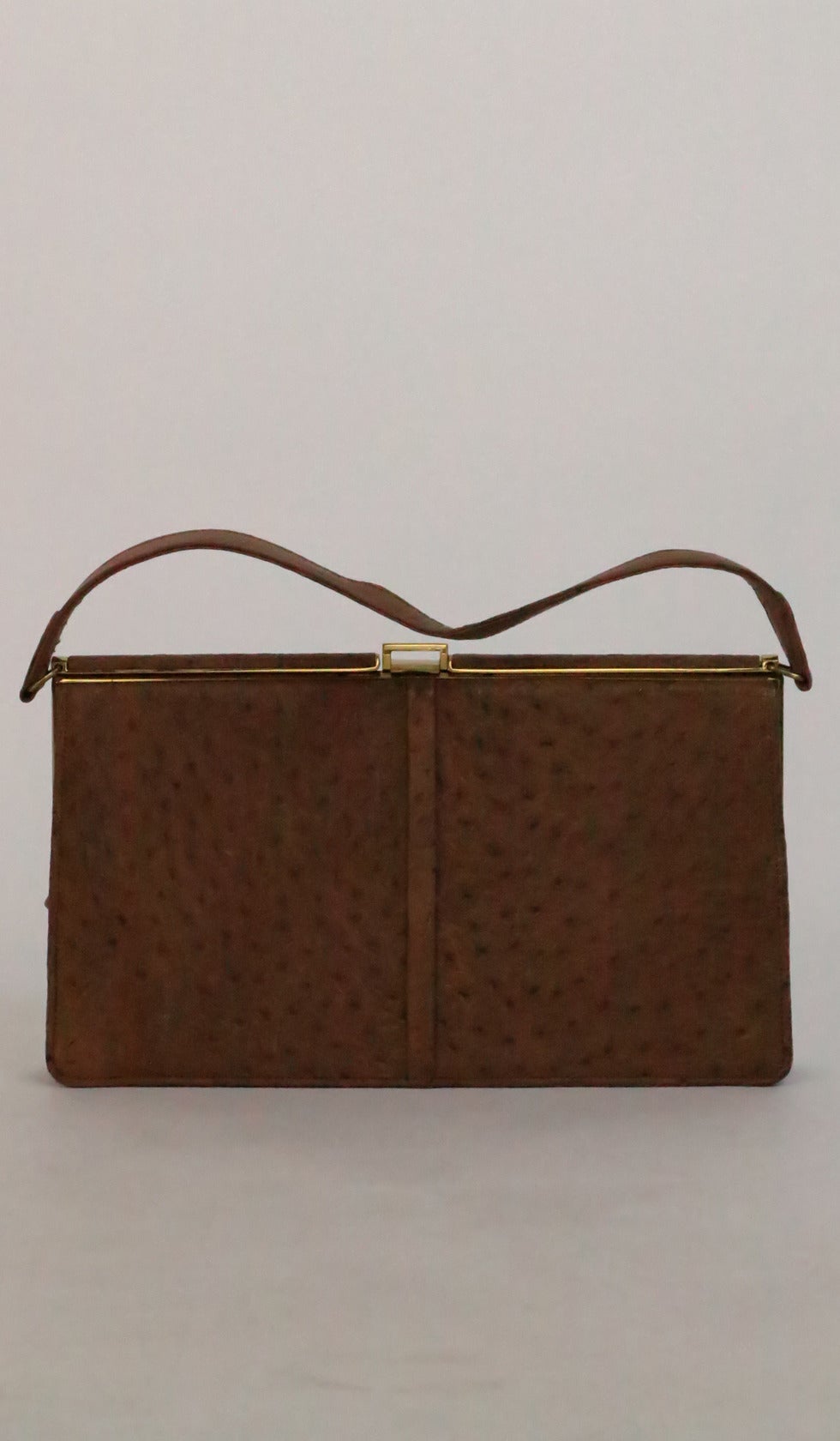 Fassbender was an luxury English leather goods company, their first bags appearing around 1930…Hand made with quality exotic skins the bags are collectable today…1950s handmade bag of camel tan ostrich skin, this is a classic structured shape frame