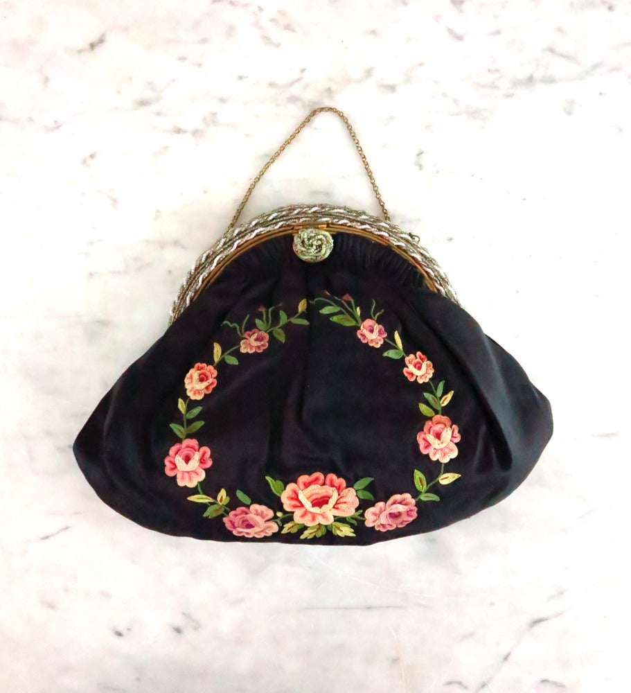 Romantic rose floral embroidered black silk evening bag…From the 1940s it is in excellent condition…The frame is matte gold metal covered with silver & pale pink seed beads…The bag closes with a rosette of beads at the front (lift and pull
