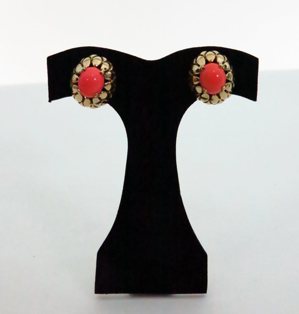 Divine, signed Panetta clip back earrings…Open work gold setting with prong set faux coral cabochons…In excellent condition, these earrings appear unworn…

Measurements are:
5/8” high
¾” wide