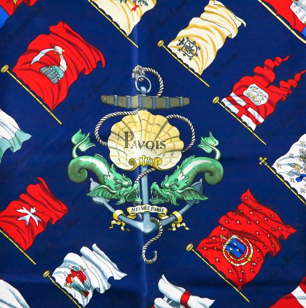 Hermes, Pavois silk twill scarf...From the 1960s and designed by Philippe LeDoux...Bright navy blue back ground with brilliant coloured flags