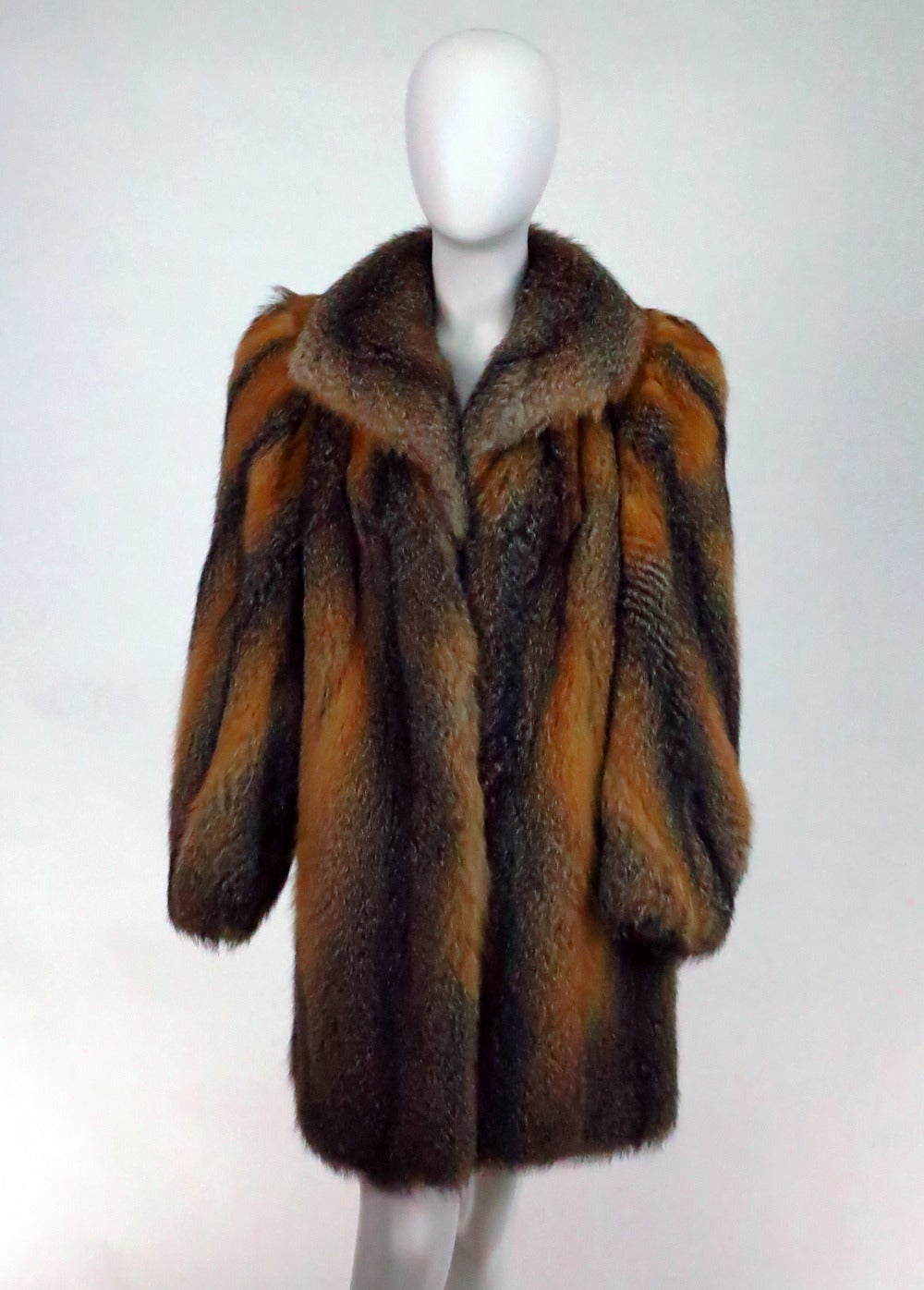 Luxurious red & silver fox fur mini coat...Long full sleeves narrow at the cuffs...On seam front pockets...Deep collar...Fully lined in gold satin...Closes at the front with hooks...Fits a Small-Medium...

In excellent wearable condition... All
