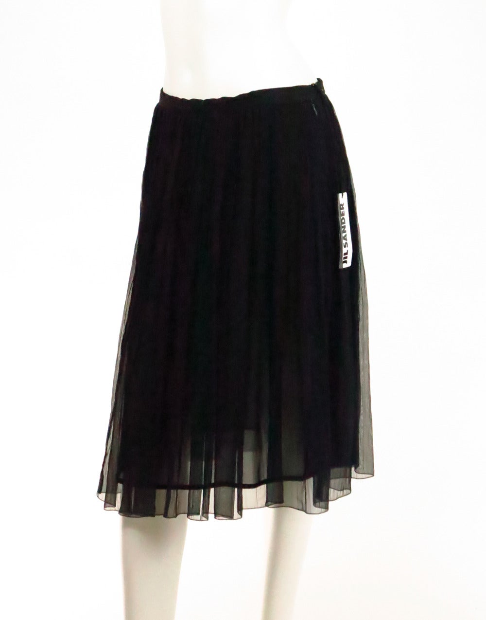 Jil sander black silk chiffon open pleated skirt...Sheer silk chiffon skirt has a waist band,  zipper closure with hooks at waist...Silk underling...New with tags...Marked size 42...

Measurements are:
Waist 31