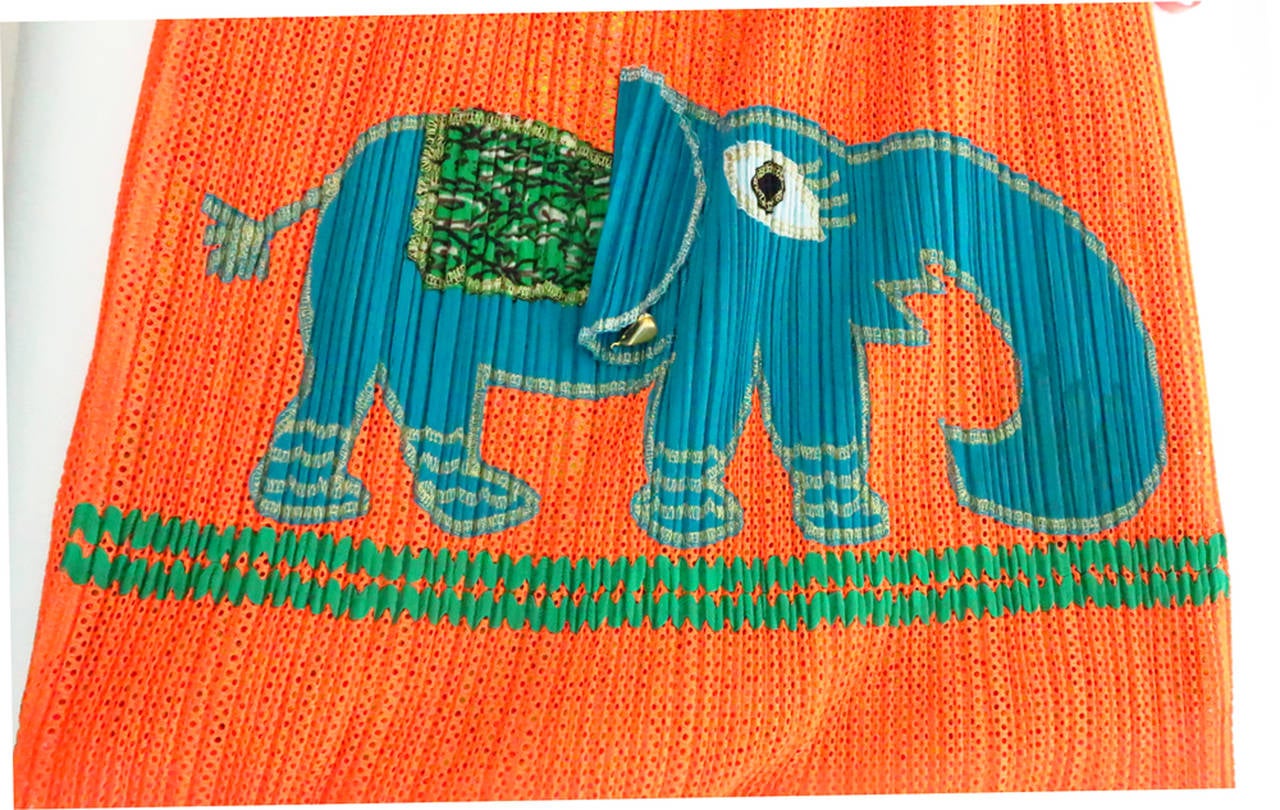 Issey Miyake Pleats Please lucky elephant tote bag...Bright orange poly mesh pleated tote is appliqued with a lovely turquoise elephant, trimmed in gold thread, with a 3D flapping ear that wears a “ruby” (prong se) earring…Lined in bright print