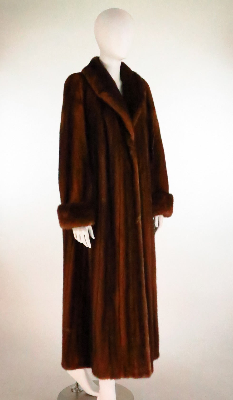 Maximilian chestnut mink full length fur coat...Beautiful warm chestnut colour coat has a shawl collar and turn back cuffs...Closes at the front with fur hooks & ties inside...On seam front pockets...Fully lined in amber crepe...Marked size