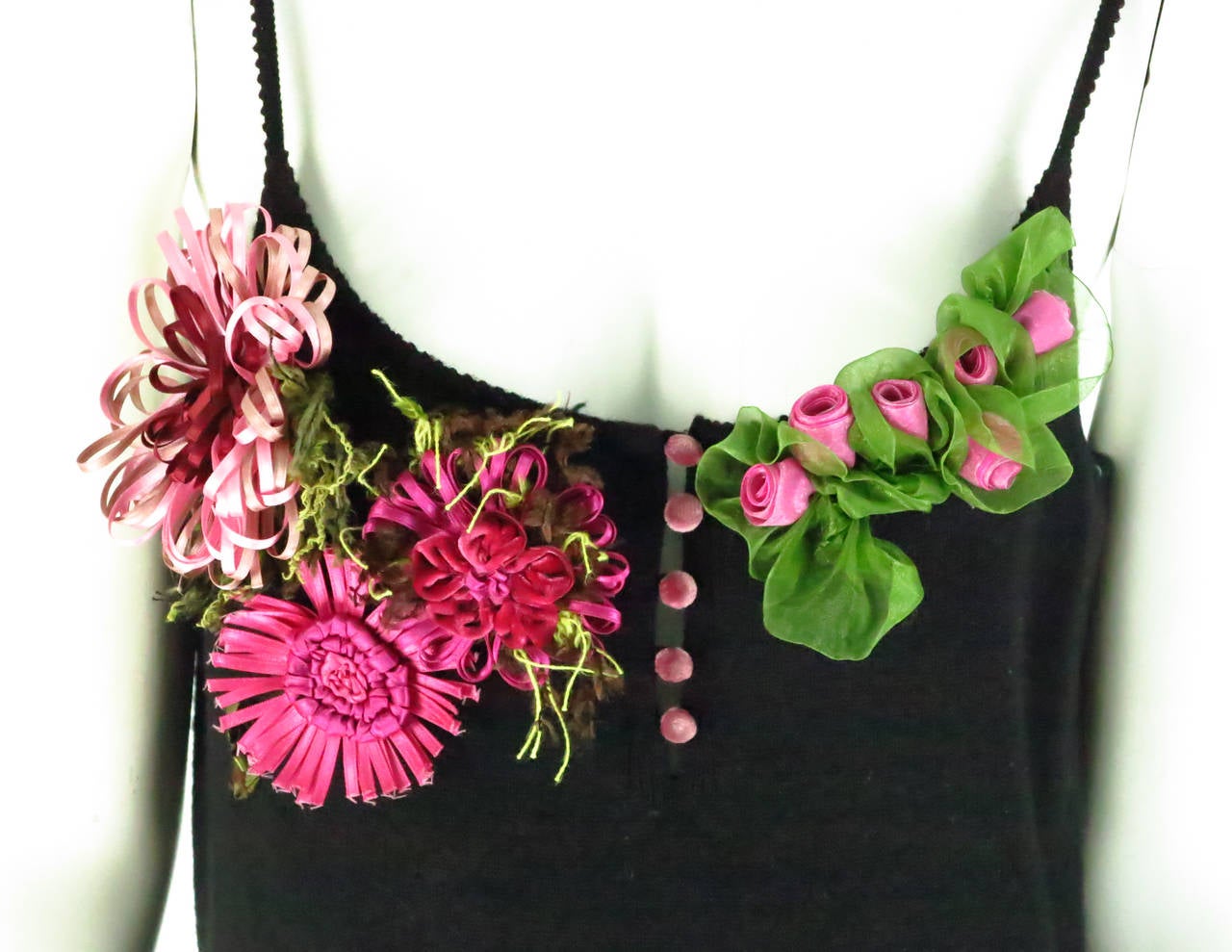 Fine black wool knit tank top with a ribbon applique bust...A gardens worth of velvet, satin and organza flowers at the upper bust, with pink velvet buttons at the front center giving a peek of skin...The wool is soft...Narrow shoulder straps with a