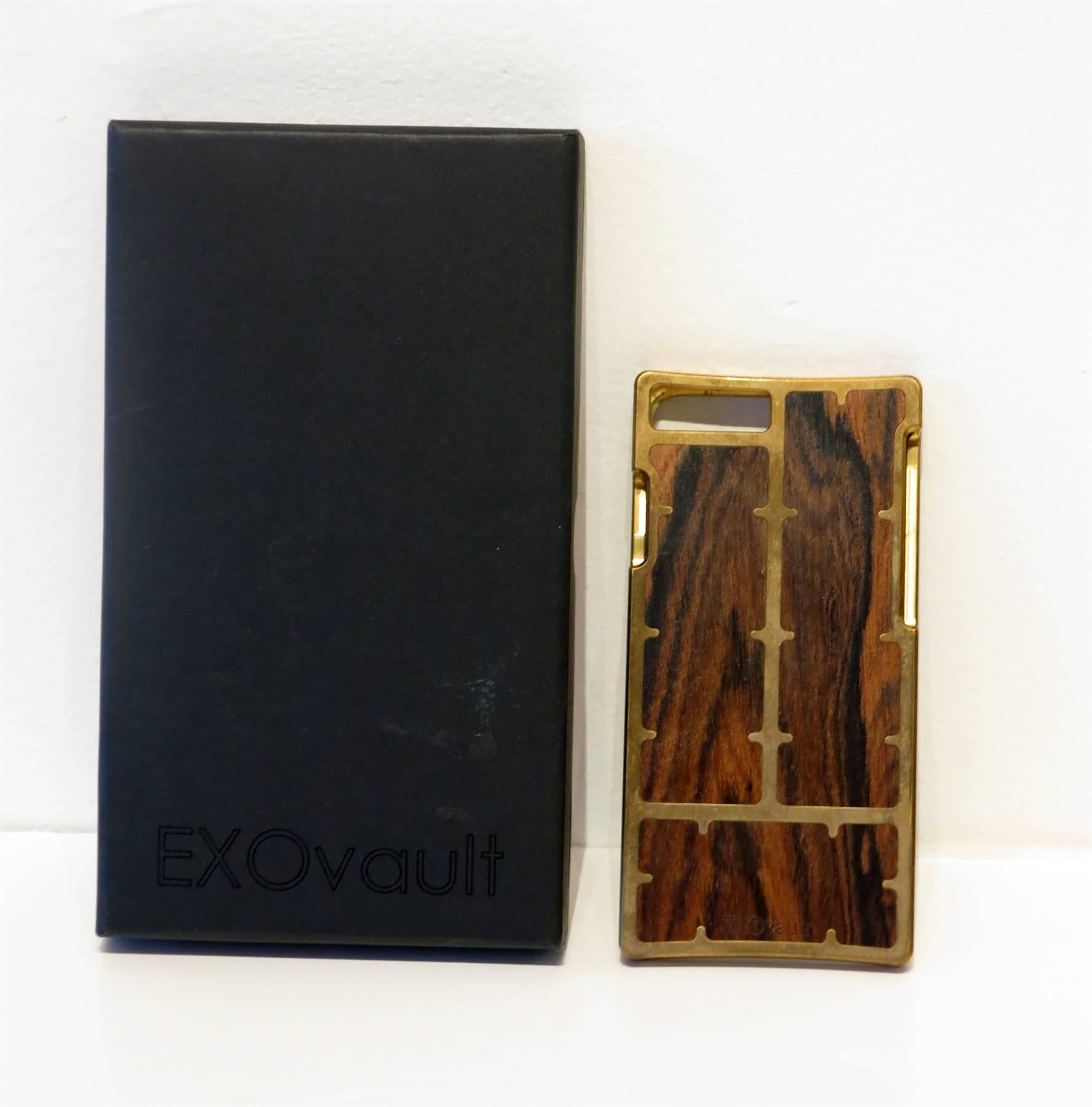 EXOvault Brass Louro Preto Iphone 6 case wood & brass new in box...The EXO23, with its hinged clamshell design and magnetic closure, provides distinct and elegant protection for your iPhone...
Measurements for iphone6: 
x 5.44 x 2.64 x 0.28 inches