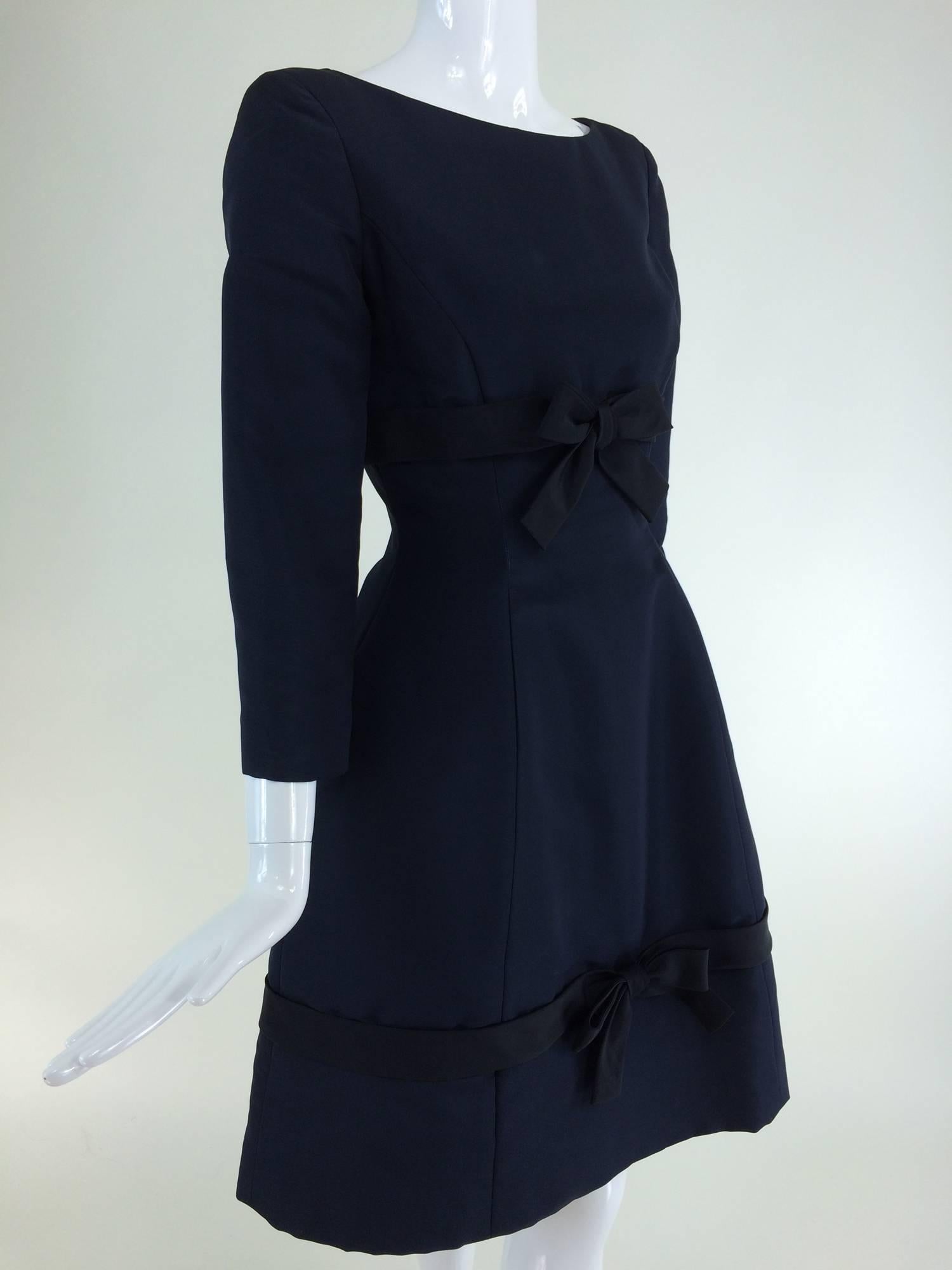 Oscar de la Renta classic navy blue silk bow front dress from the late 1960s...Bateau neck dress with princess seams has bracelet length sleeves, an applied black silk band under the bust with a bow tie at the front, the skirt is bell shaped with a