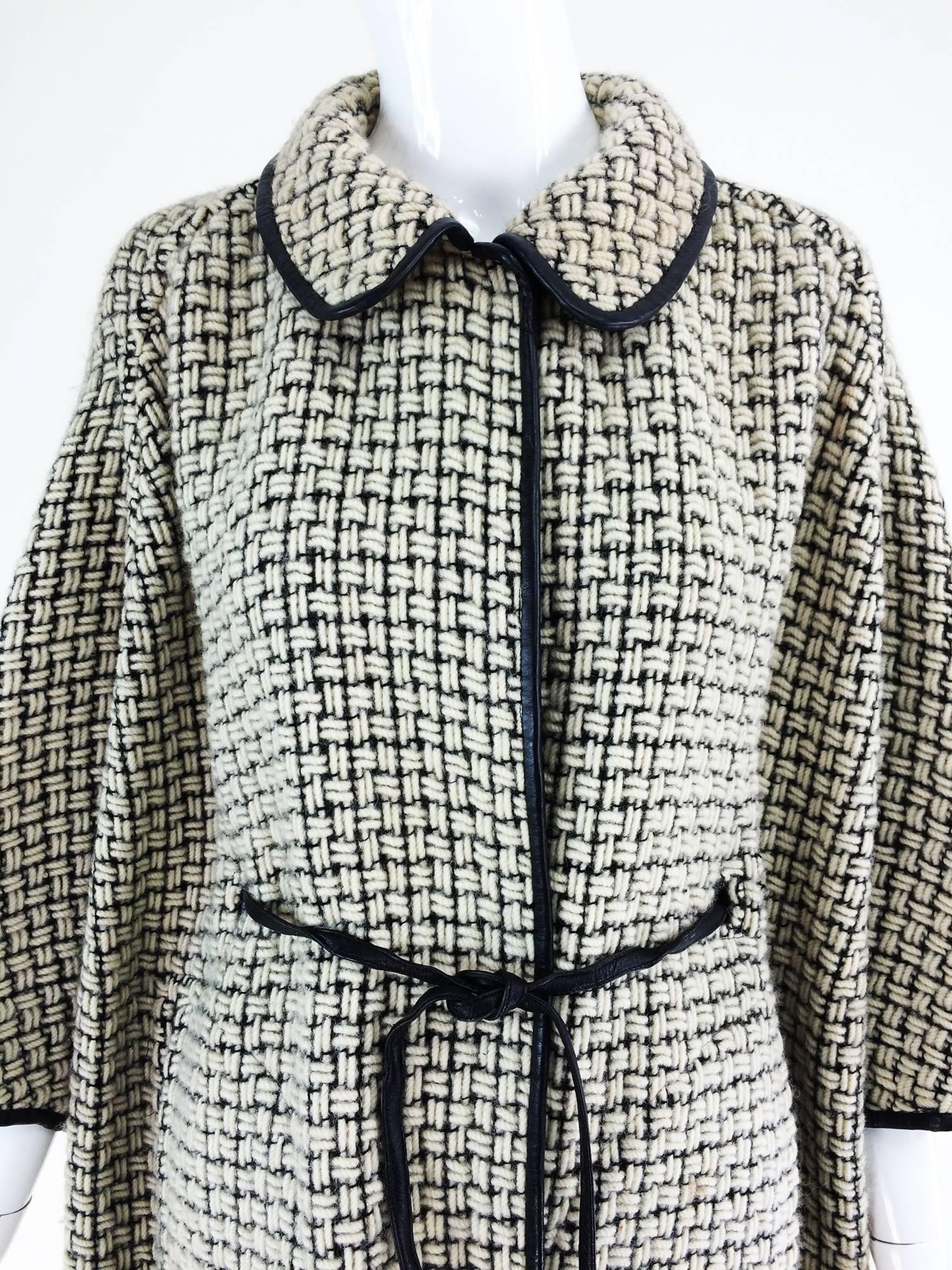 Bonnie Cashin black & white woven wool sac back coat 1950s...Casual and very stylish coat in an interesting box style weave of thick ivory wool yarn and heavy back thread...The coat is unstructured, with bat wing sleeves (although the back of the