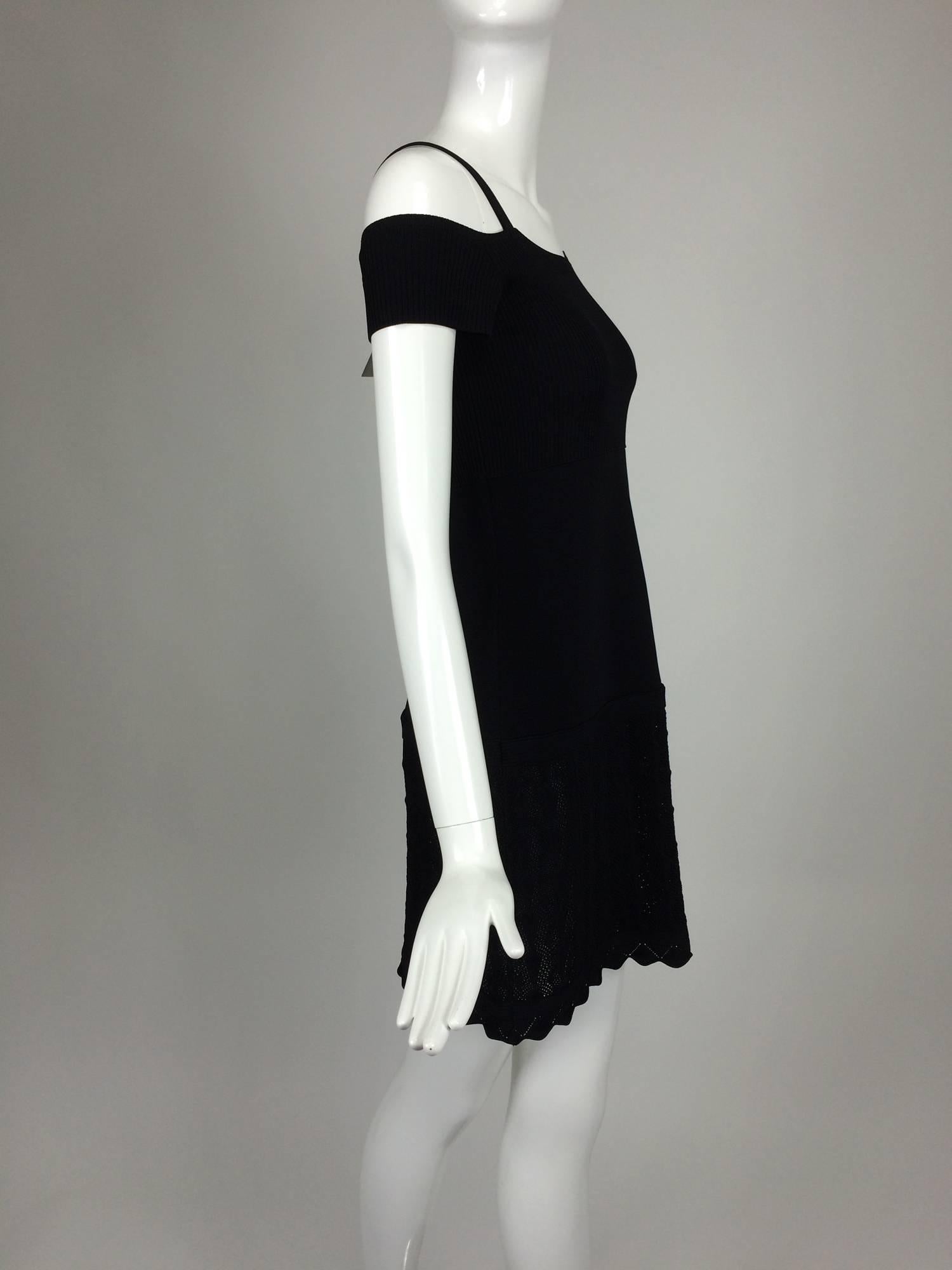 Chanel shoulder baring little black knit dress 2008 unworn...Ribbed banded cuffs that sit off the shoulder, there are narrow straps that sit at the shoulder top...Ribbed bodice, with flat knit upper skirt, a band at the hip, the lower skirt is done