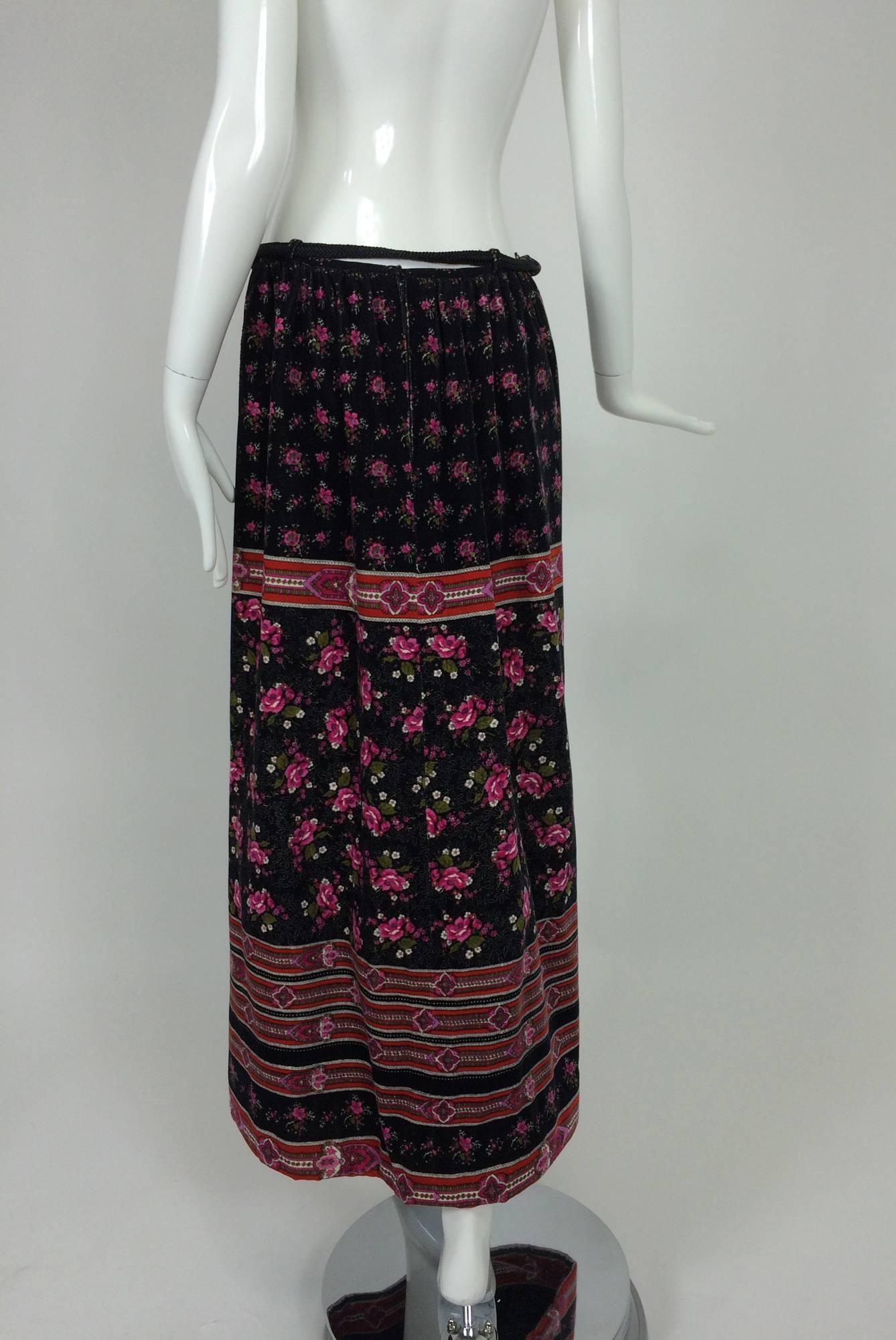 Lanvin floral printed velvet maxi skirt with tassel cord belt 1970s...Romantic print with a black ground, lots of roses...Narrow band waist with soft gathering below...The skirt is fully lined...Belt loops with the original braided cord belt that