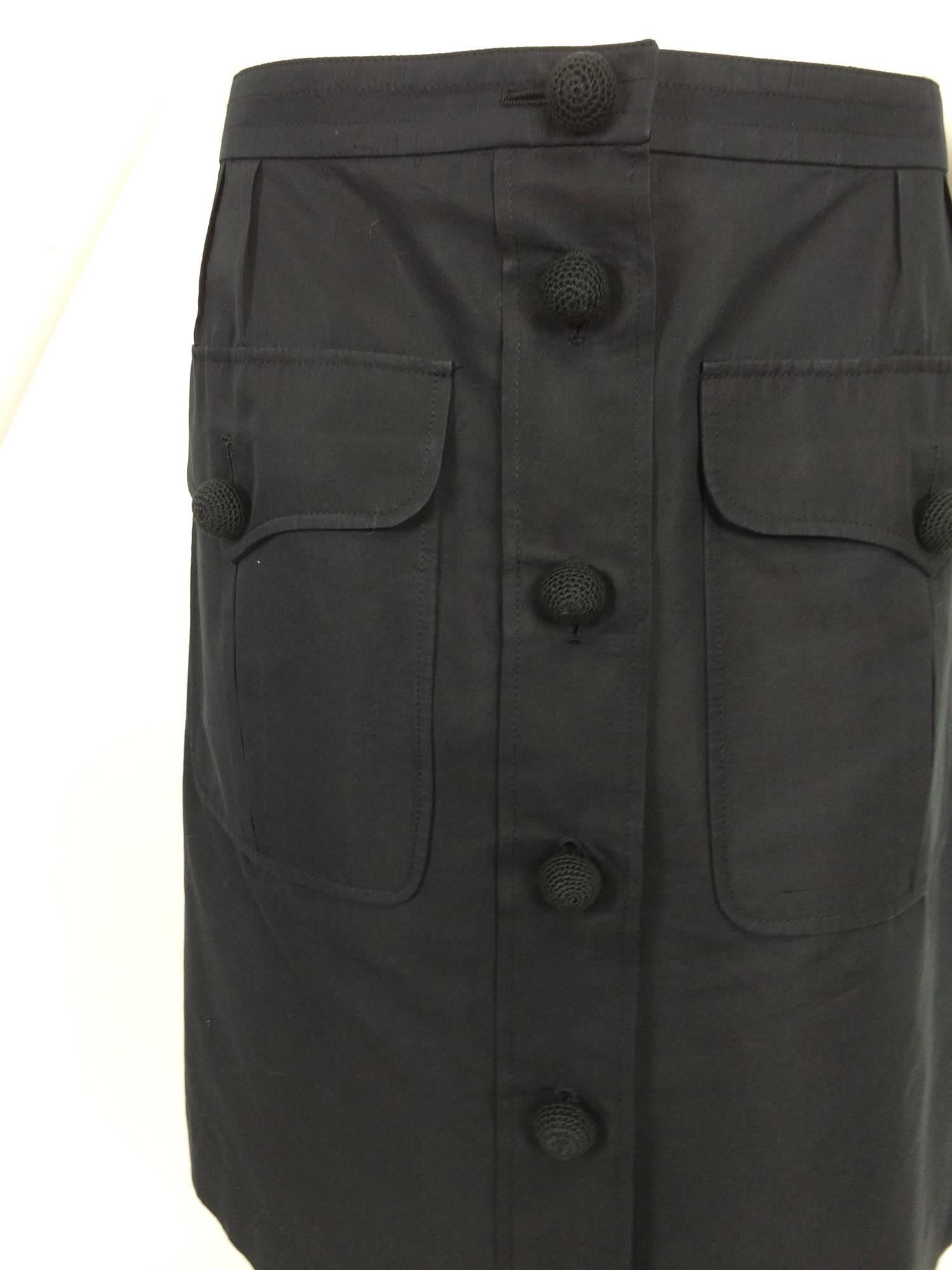 Yves St Laurent black cotton & silk flap pocket skirt with crochet buttons...banded waist skirt closes at the front with domed crochet buttons, there are two large hip front pockets that have flap/button closures...The skirt is unlined...Marked size