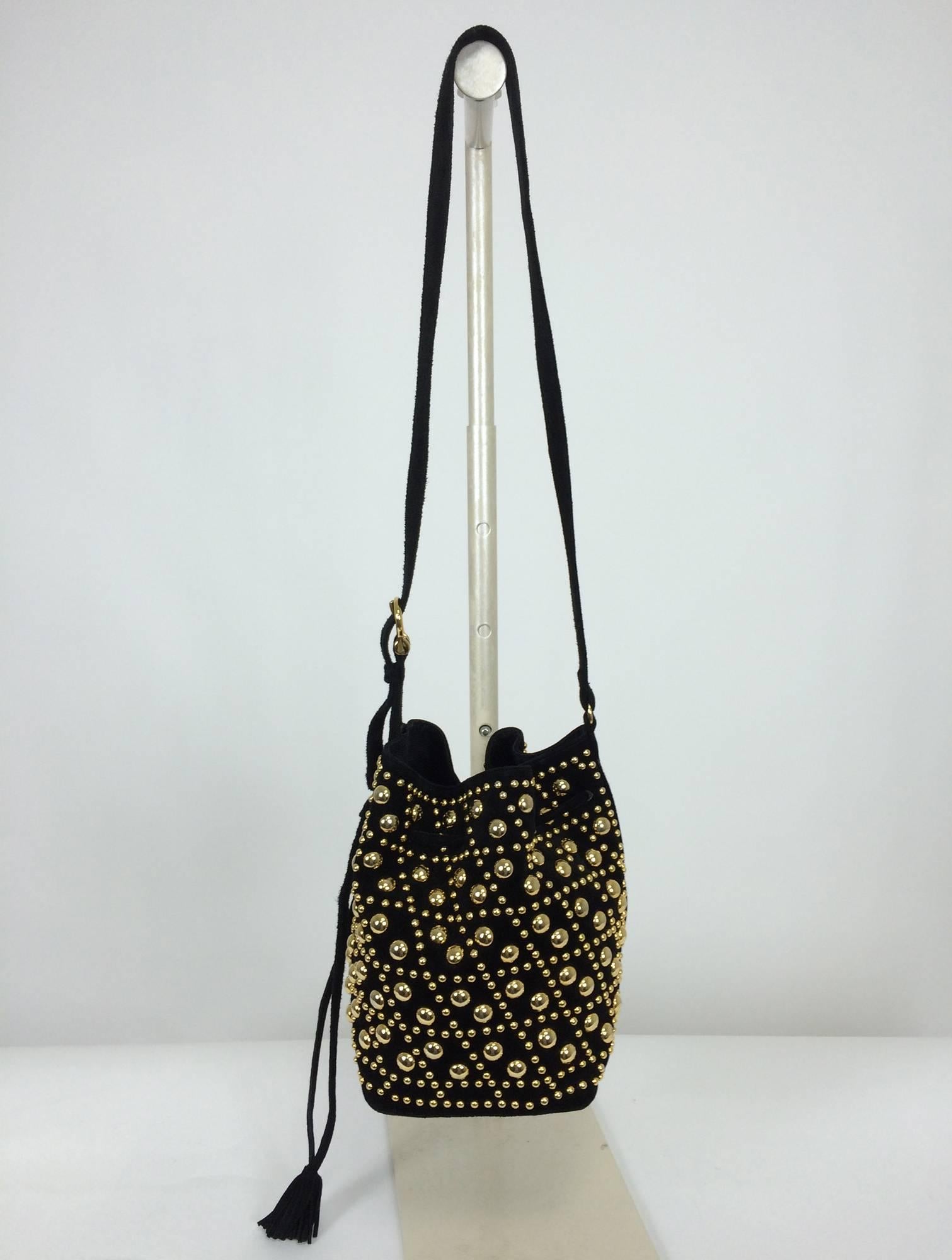 Gold studded black suede shoulder bag Sepcoeur Paris 1980s...Soft black suede shoulder bag is heavily studded with large and small gold studs...The long shoulder strap has a gold buckle and can be adjusted...There are 4 gold feet at the bottom...The