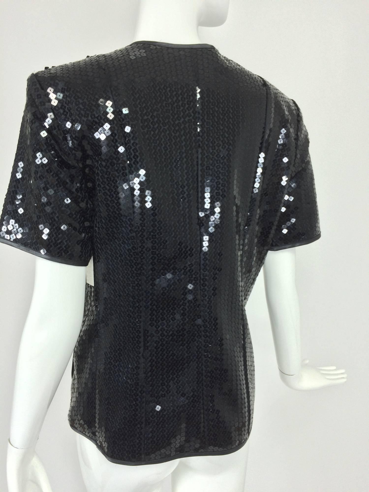Yves St Laurent black sequin short sleeve evening jacket 1980s...The Variation label is from the 1980s...This jacket has a lot of style...Single breasted with three button closure at the front, facings are trimmed in black satin...The jacket is