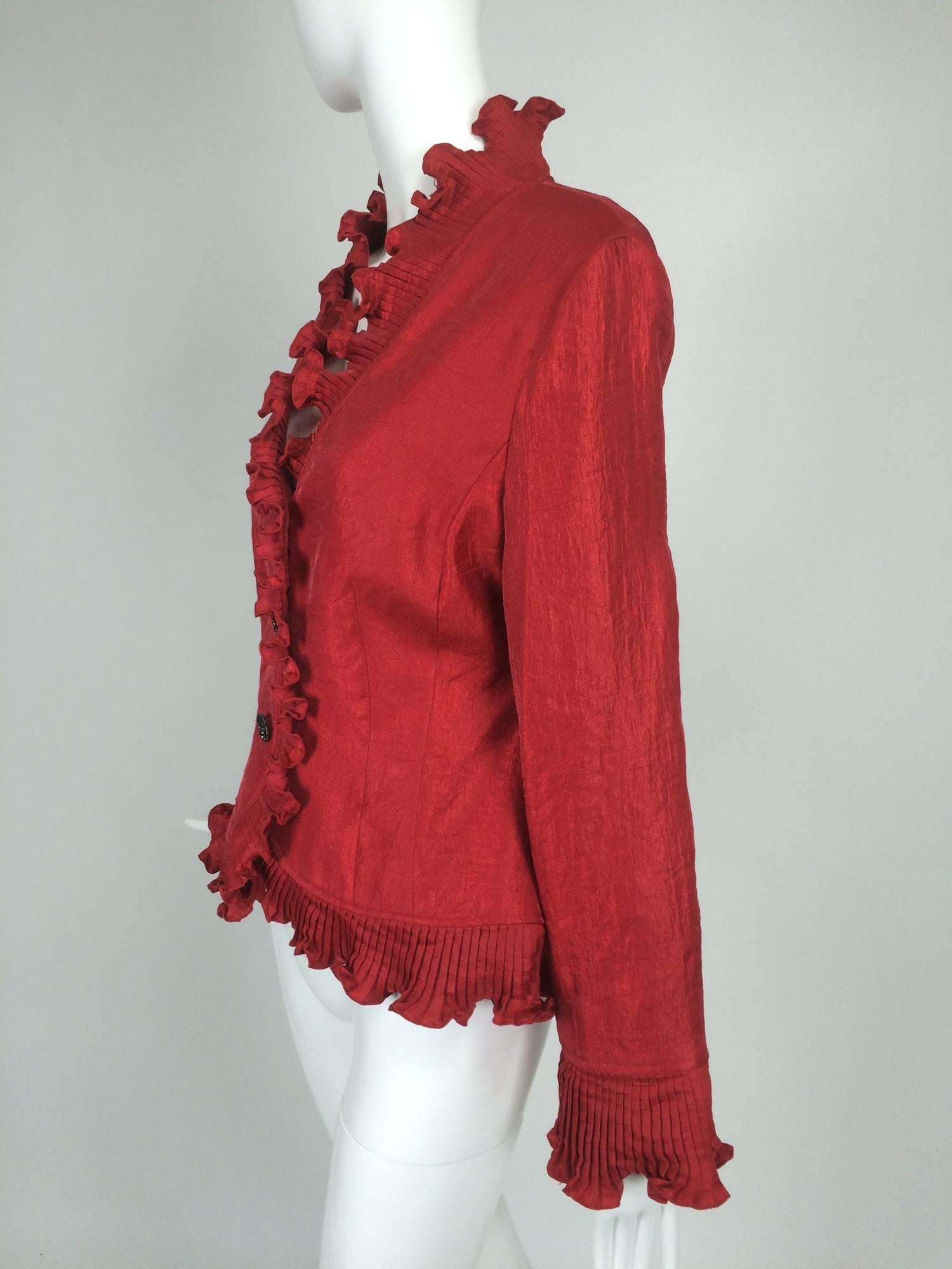 Victor Costa shimmery red evening jacket with pleated ruffle trims...Button front jacket closes with round multi black rhinestone buttons...Accordion pleated ruffle at all facings...Jacket has a V neckline...Long sleeves...Hip length...Fully lined