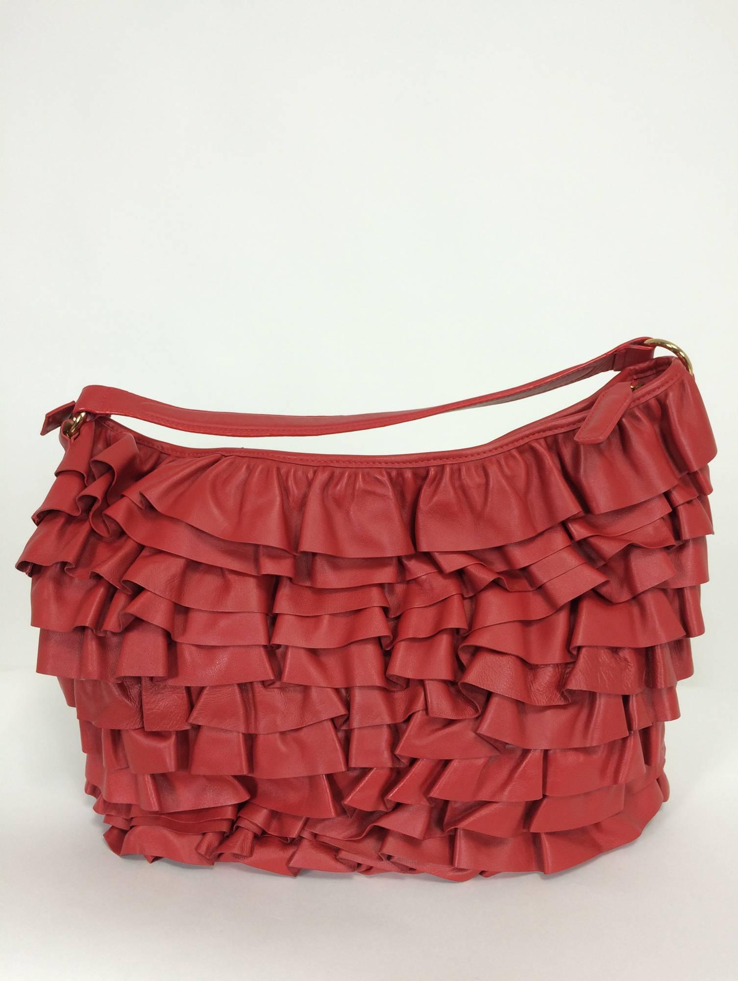 Valentino large red leather ruffle shoulder bag...Padded shoulder strap, gold strap rings, leather tab zipper pull...Deep soft red leather ruffles all around the bag...Gold metal logo plate at the lower front of the bag...The lining is silvery satin
