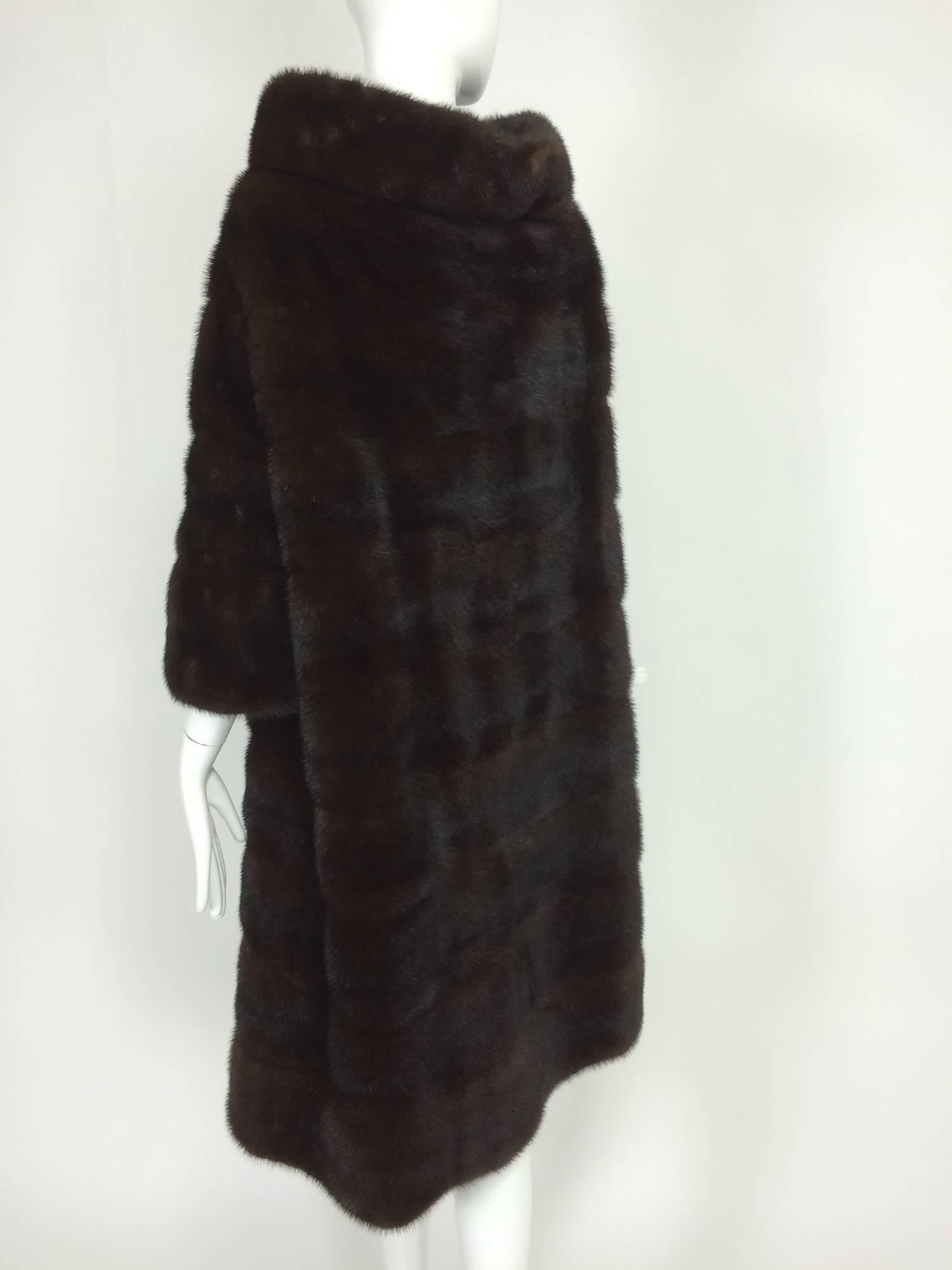 Glossy dark mink portrait collar fur coat early 1960s...Fabulous coat from the early 1960s...The fur is pieced horizontally which gives it a unique look...The portrait collar is meant to frame the face...Bracelet length sleeves are perfect when worn