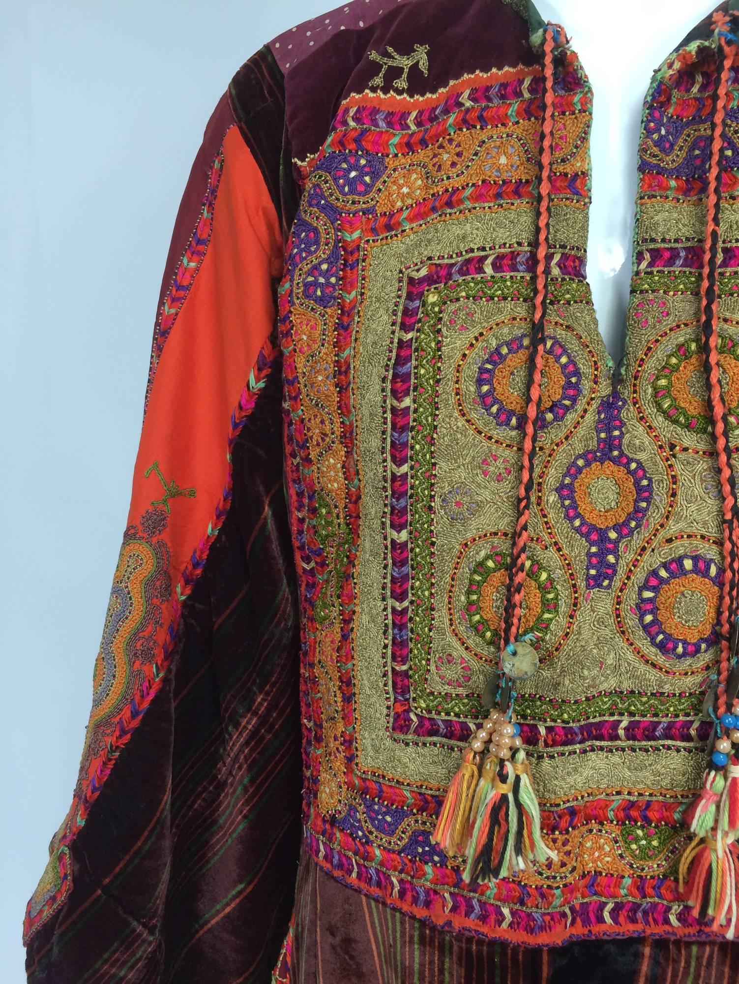Mid 20th C. Palestinian traditional embroidered velvet robe...A beautiful robe of rich velvet in stripes of varying widths of wine, amber & green...Densely embroidered front panel of fine burnished gold and silver cord work and brightly coloured