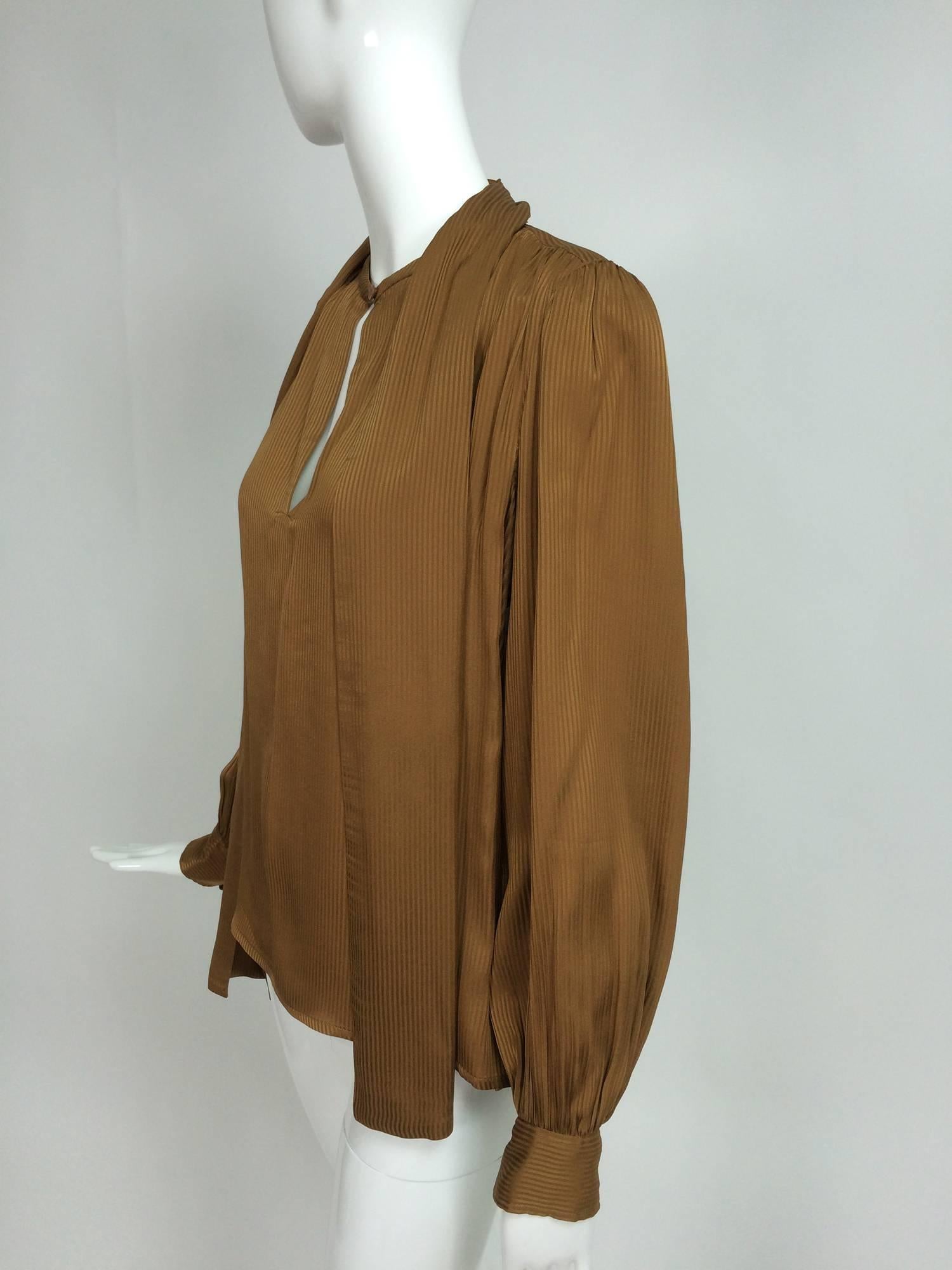 Yves St Laurent Rive Gauche tobacco silk tripe tie front blouse 1970s...Long sleeve blouse has a neck center front vent with a button and loop closure, there are long attached self ties at the neck...Pull on style blouse has a shoulder yoke front