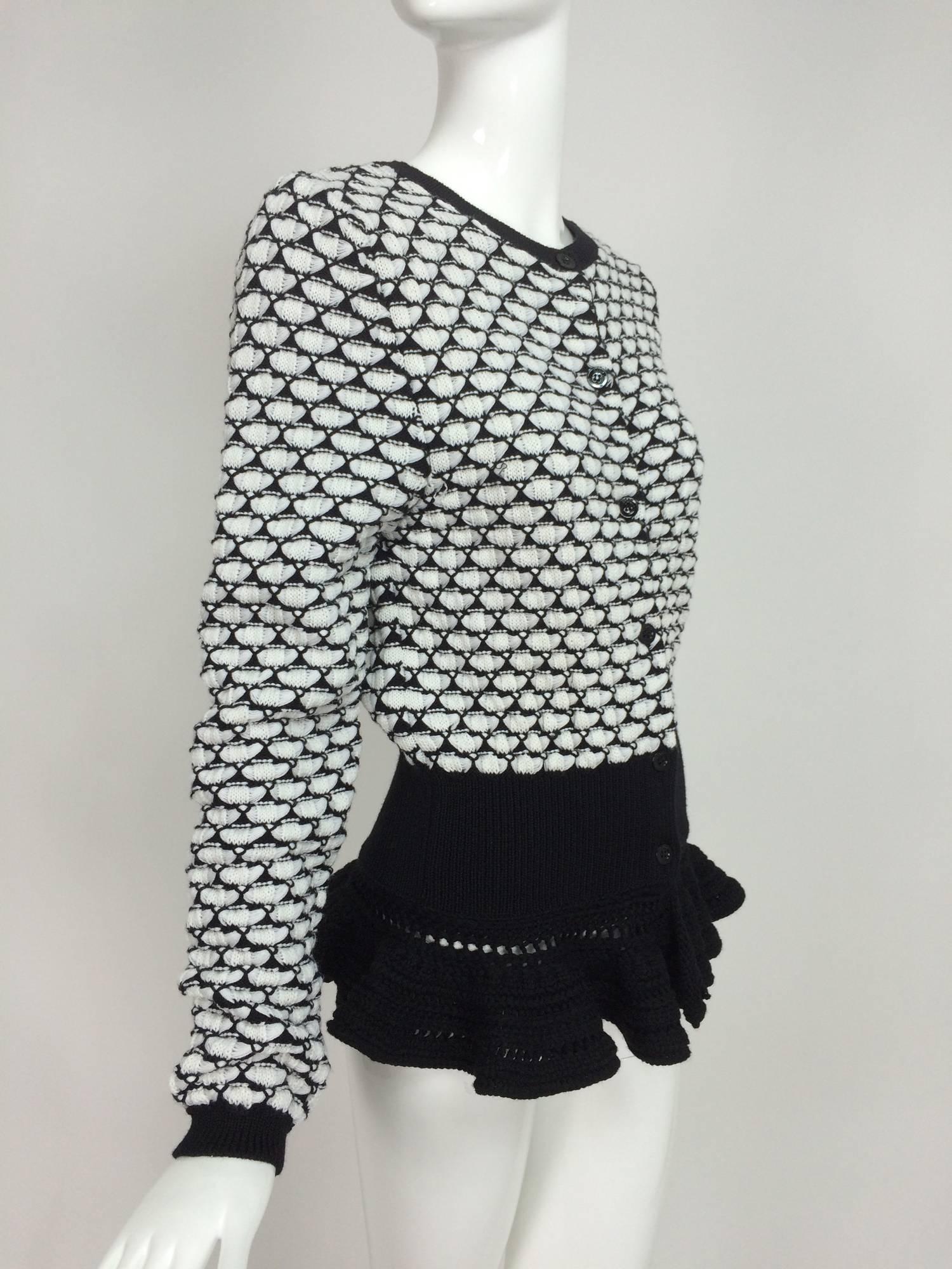 Christian Dior black & white wool knit cardigan sweater with a crochet ruffle hem...Fancy knit sweater closes at the front with buttons...Wide hip band and crochet ruffle hem...Unlined...Marked size 10 US...In excellent condition..

In excellent