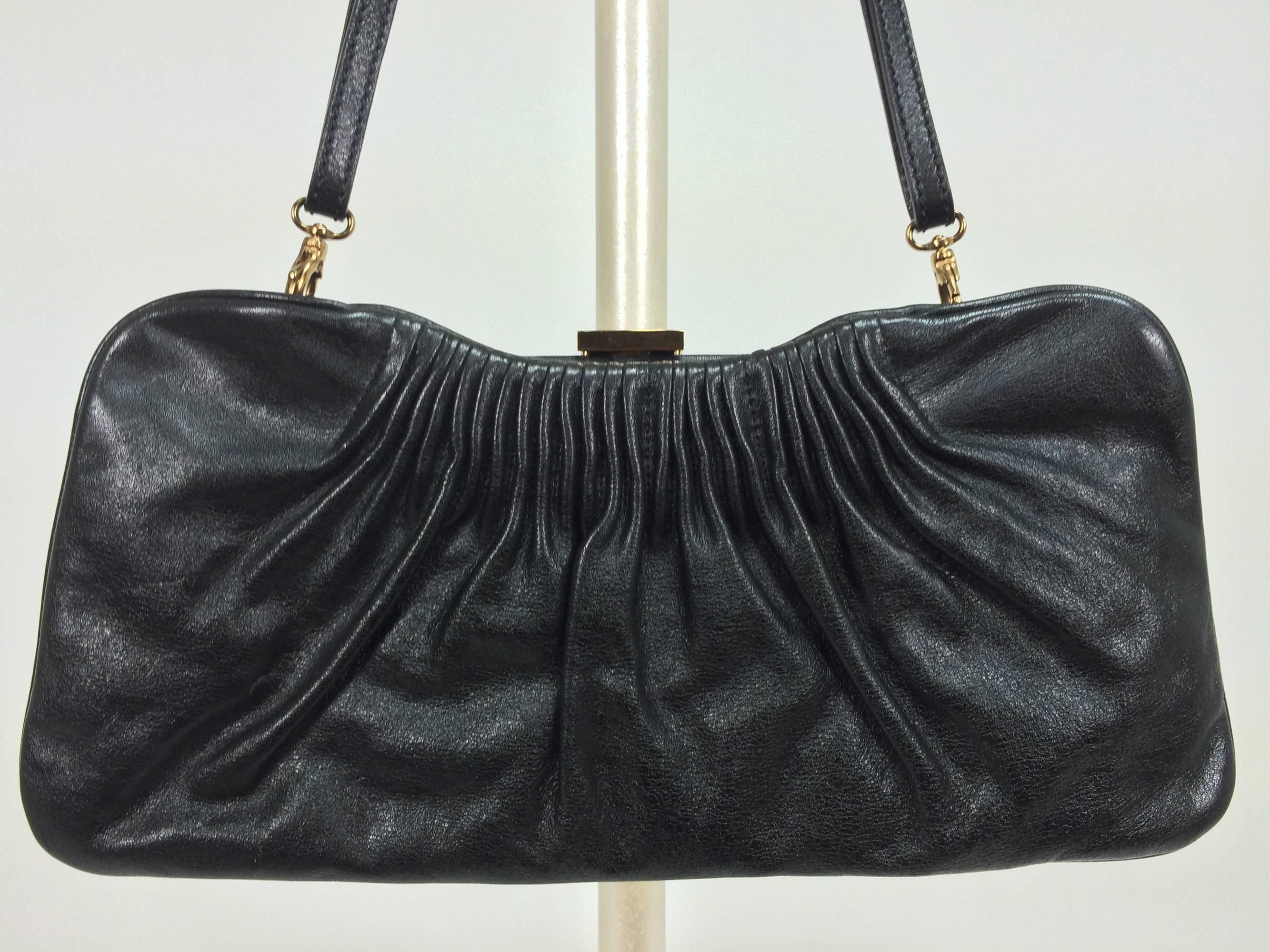 Escada black leather frame bag convertible clutch or shoulder handbag...Black leather frame bag has gold logo clasp and attachments for the removable strap...The bag is pleated at the top on both sides...Inside the bag is lined in brown fabric,