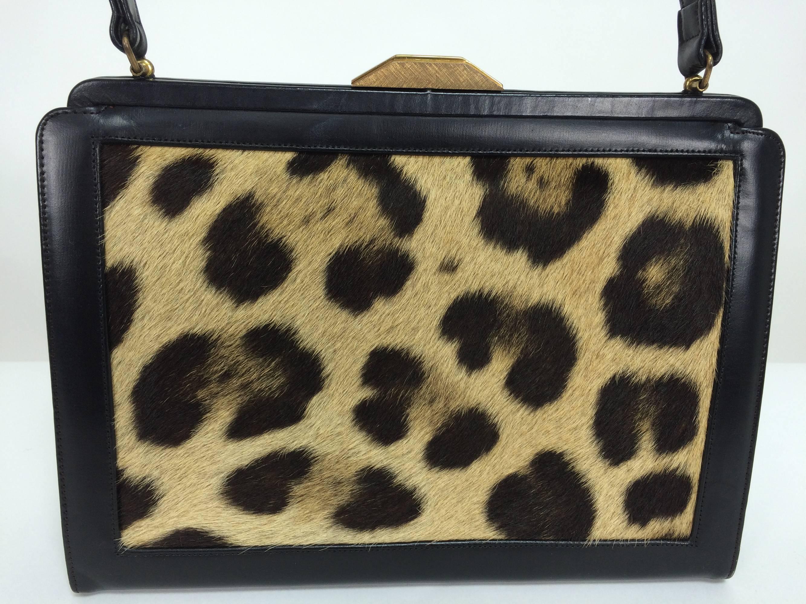 1950s black leather and spotted pony frame handbag...Black leather handbag with textured gold clasp, the front and the back of the bag are inset with panels of spotted fur...The bag is lined in black leather and has a side zipper compartment and a