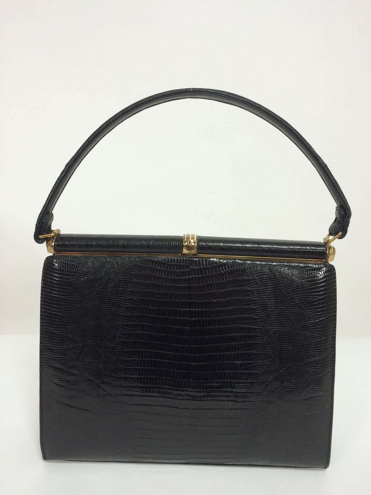Lucille de Paris glazed black lizard frame handbag 1960s...A beautiful handbag from the early 1960s, with gold hardware and a skin covered frame...The bag features two flap pockets at the front each closing with a hidden snap...There are gold metal