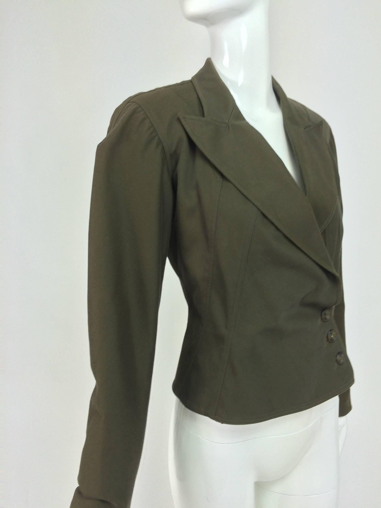 Alaia olive green fitted side front button jacket 1980s...Raglan sleeve jacket has a deep neckline with wide lapels...Seamed to a fitted waist and flares at the hem...Back waist seaming...The jacket closes at the front side with buttons (interior