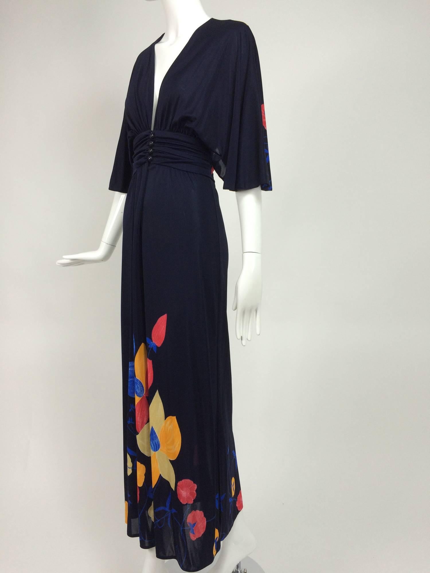 Mac Tac of Paris dark blue colourful floral jersey maxi dress 1970s...Silky nylon (feels nice) in dark navy blue with a bright primary colour print...The dress has a deep plunge neckline and closes at the waist with buttons and a hook &