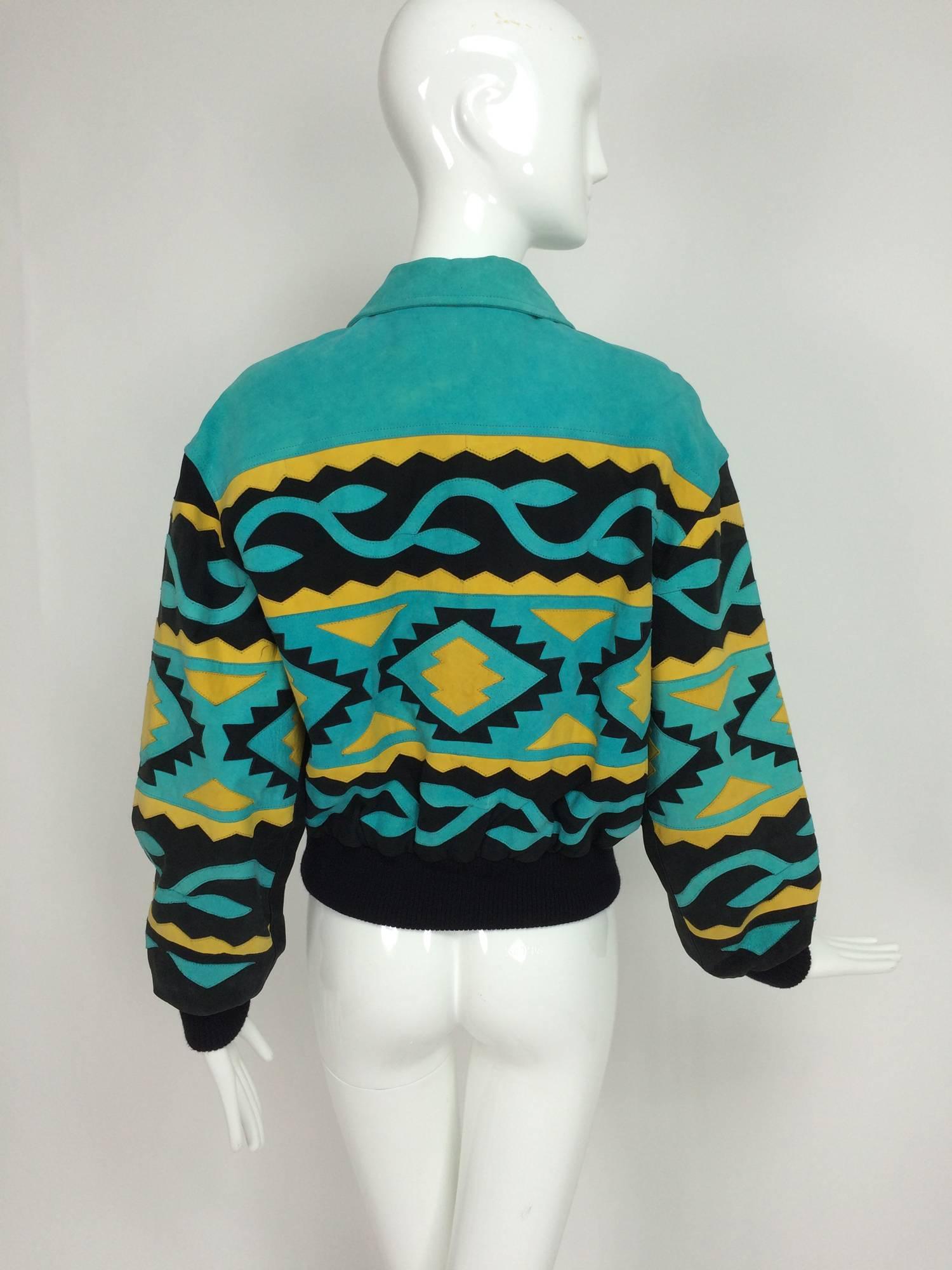 Michael Hoban for North Beach Leather intarsia suede tribal jacket 1980s. Turquoise suede with inlay of black and yellow suede in a native tribal design. the jacket closes at the front with a heavy metal zipper, with front angled pockets and a